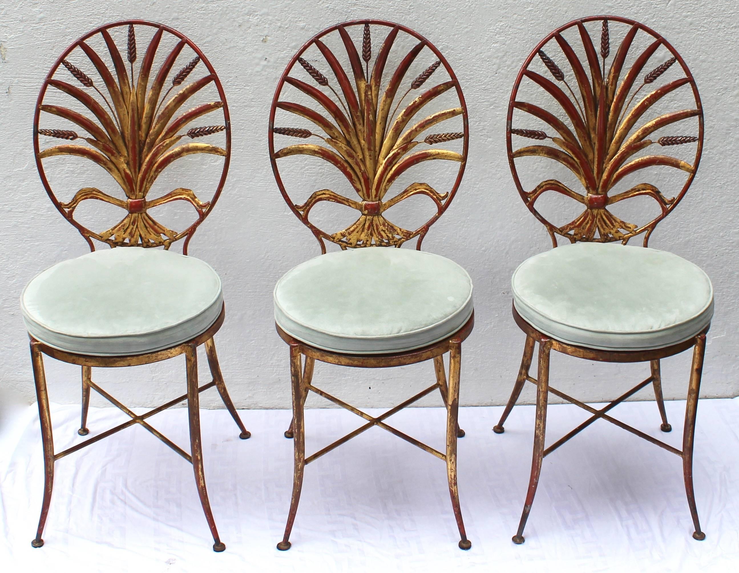 Set of three sheaf of wheat back gilt metal chairs. Round seats with custom cushions.