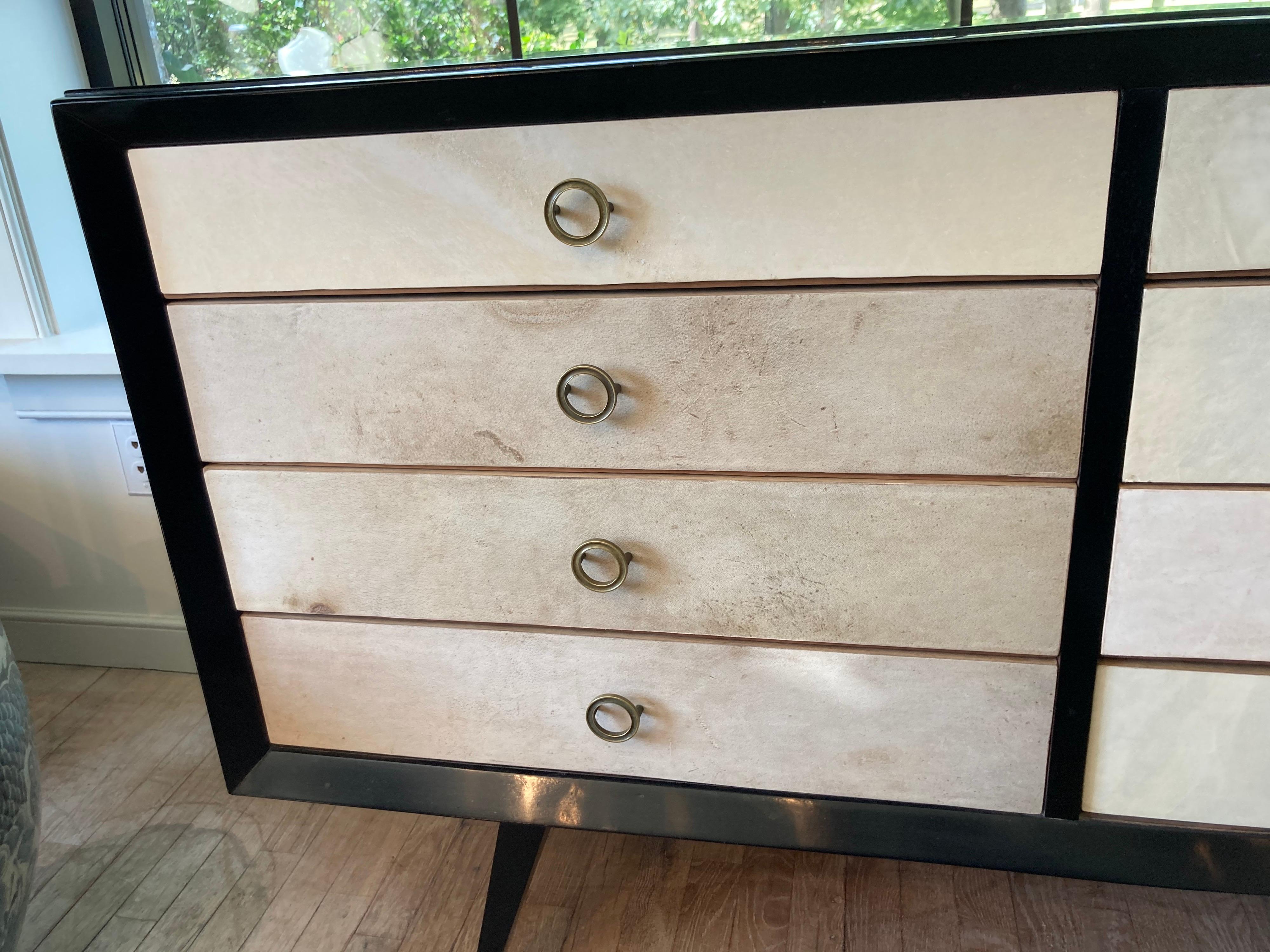 Beautiful black lacquered eight-drawer chest with parchment front drawers and elegant brass pulls.