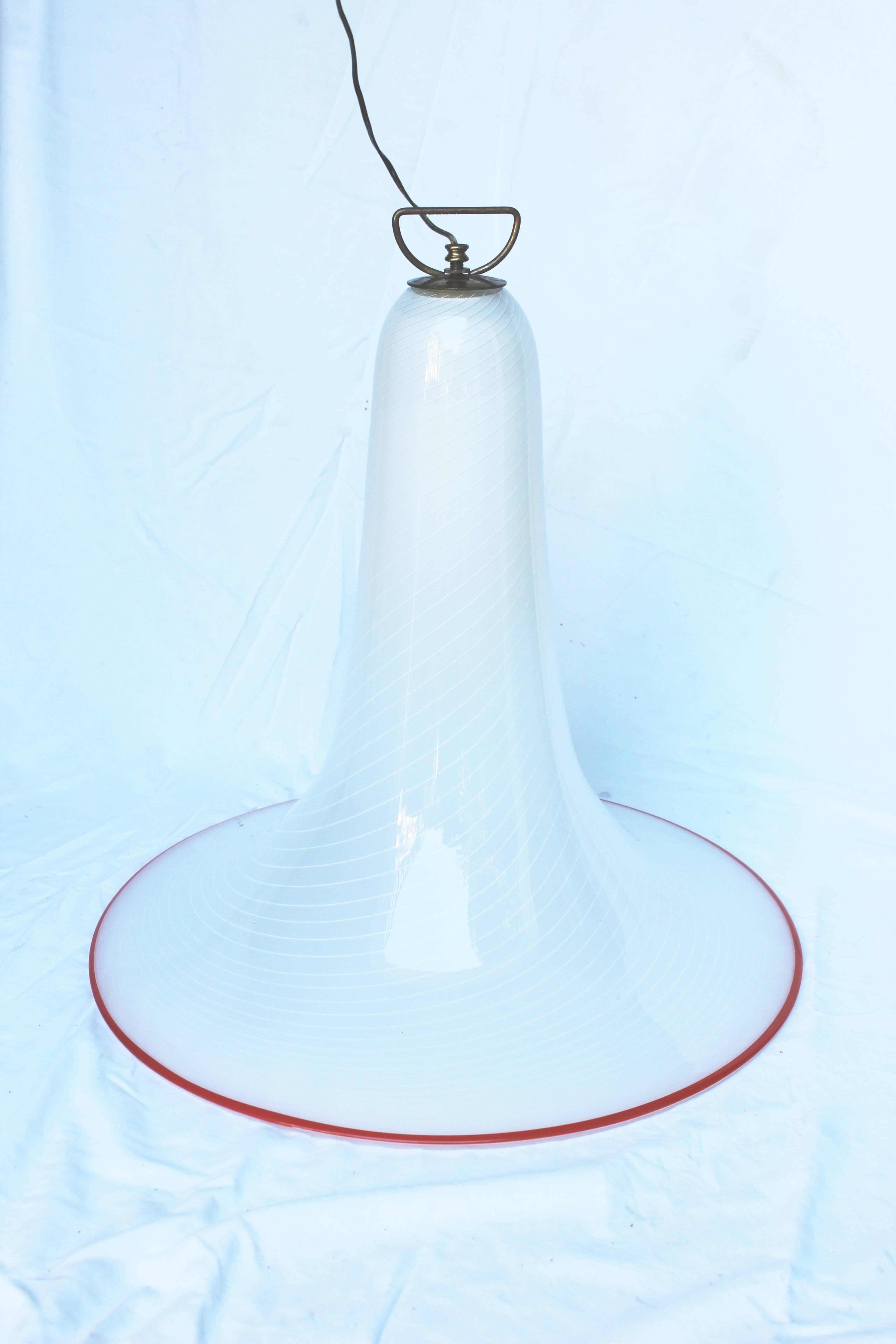 Great looking and great scale bell shaped Murano glass chandelier or pendant. White swirl with a lip in red.