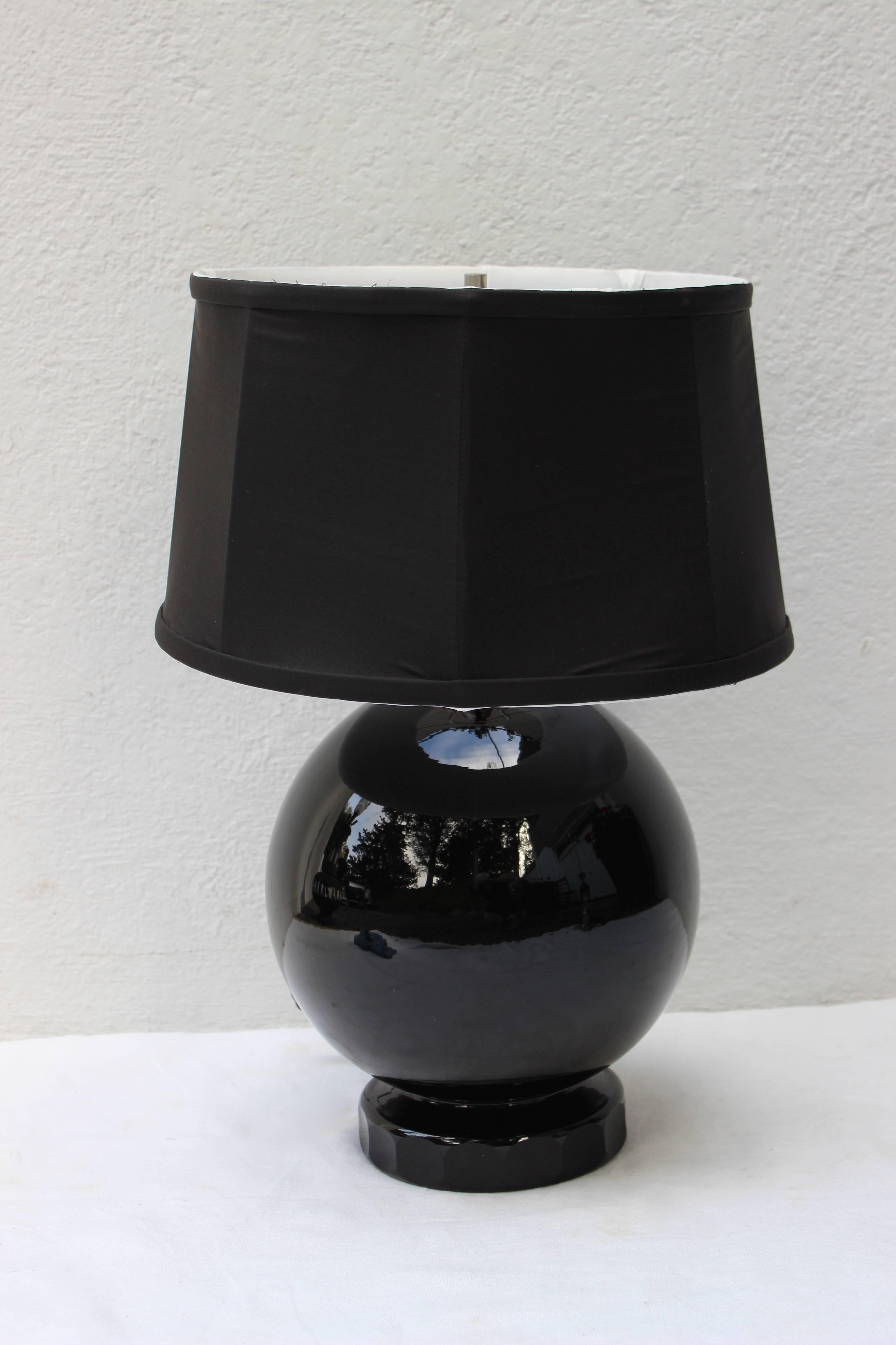 Beautiful lamp made of a sphere of black glass on a black glass base with a black silk shade and french wired......

Shade Measures 12.25