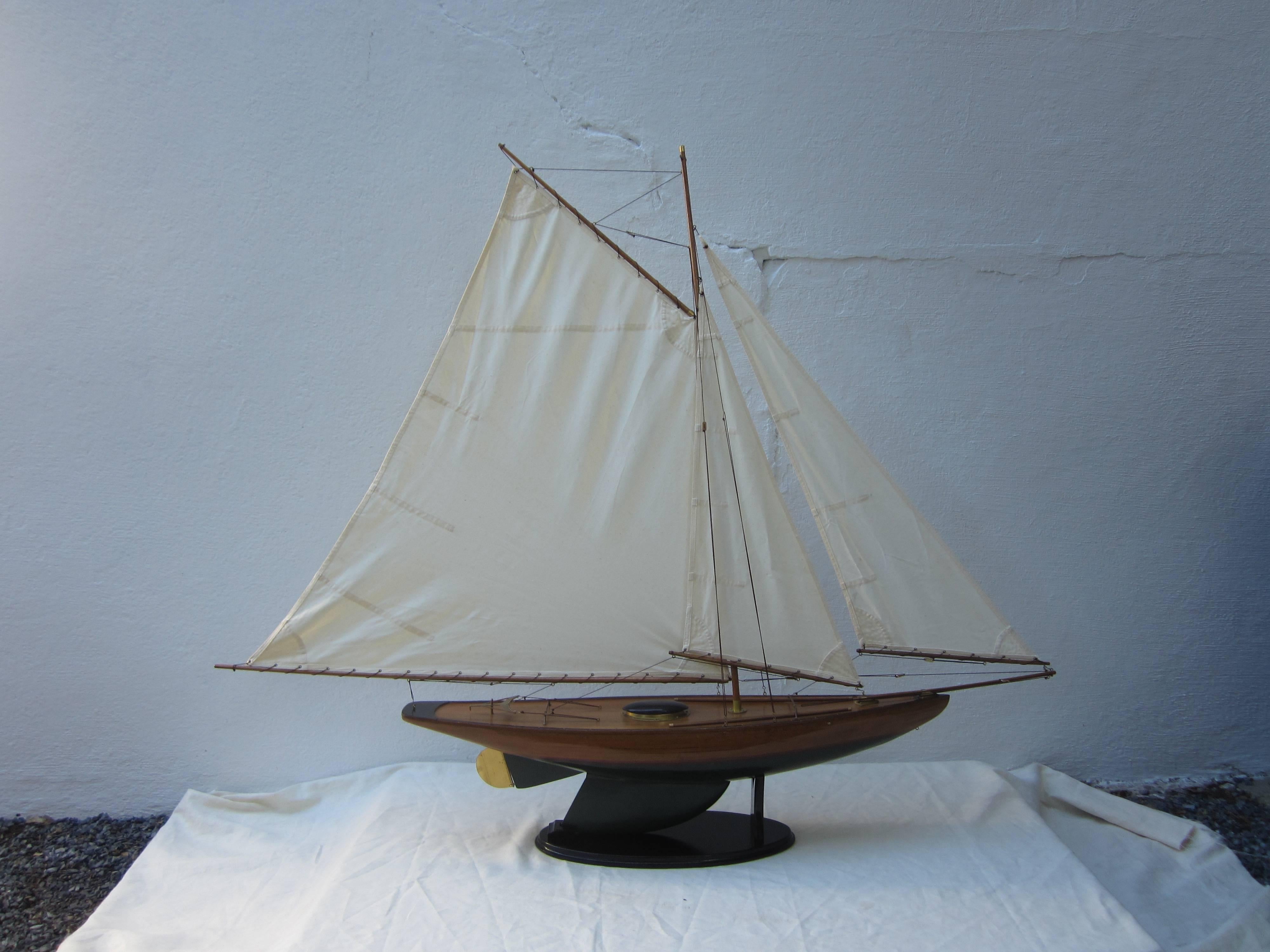 Large sailboat model on Stand with three sails. Wood body.