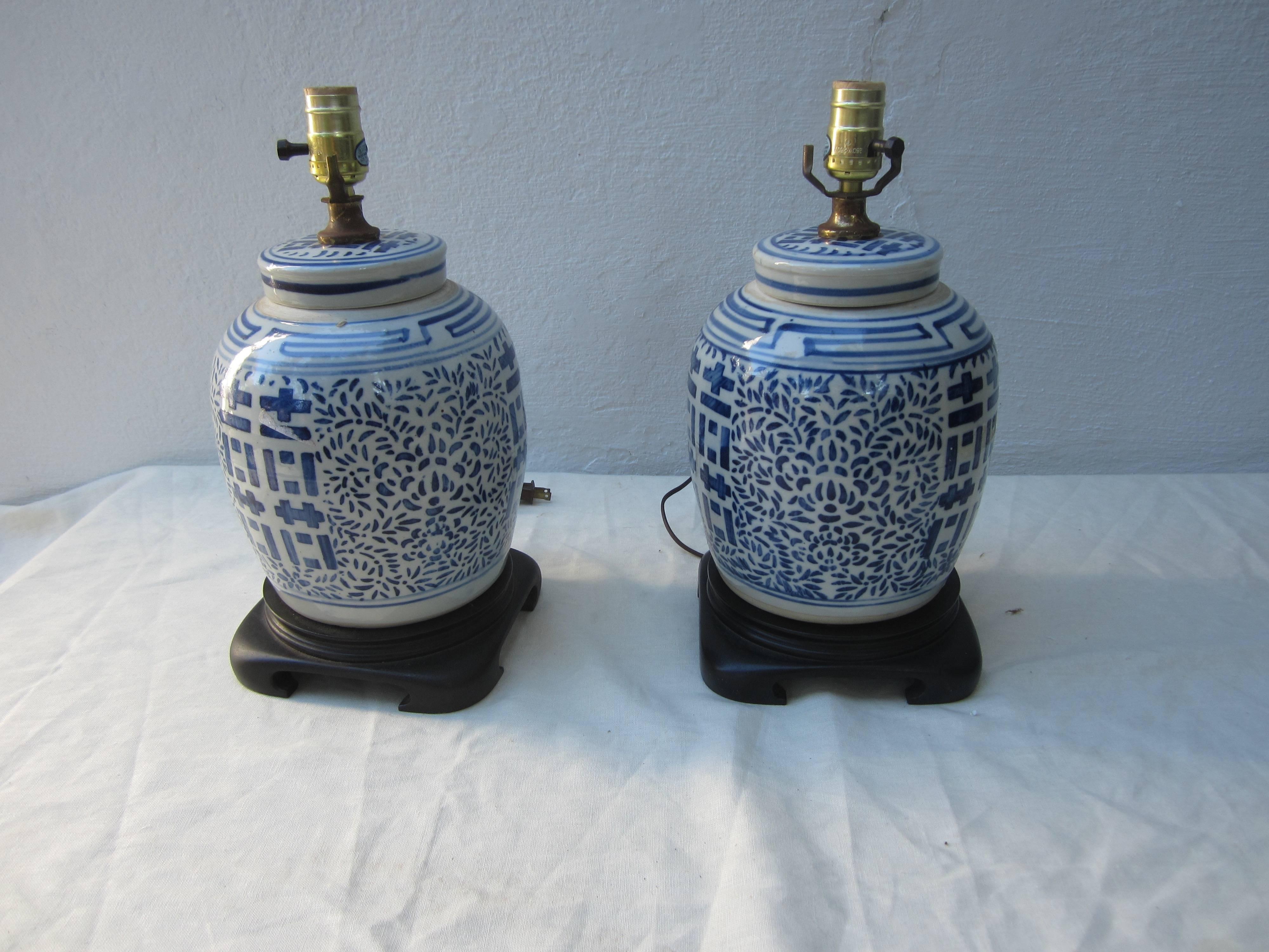 Pair of Chinese blue and white jars with lids made into lamps. Measurement to top of socket is 15.5.