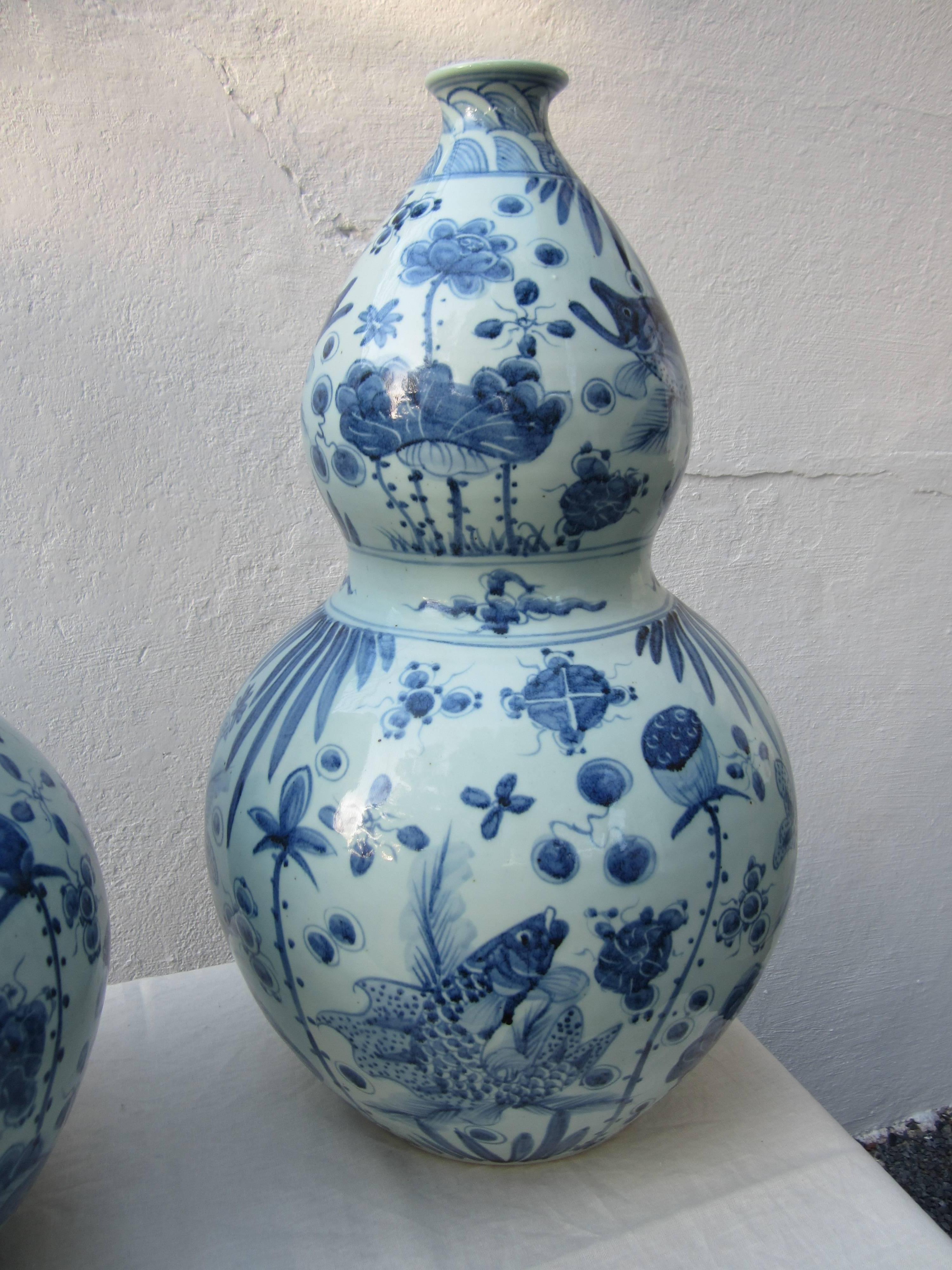 Beautiful pair of large Chinese blue and white gourd vases with painted fish.