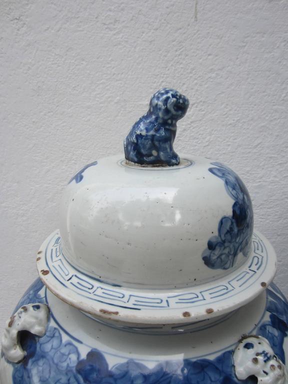 Majestic and impressive Chinese jars with lids topped by foo dogs.