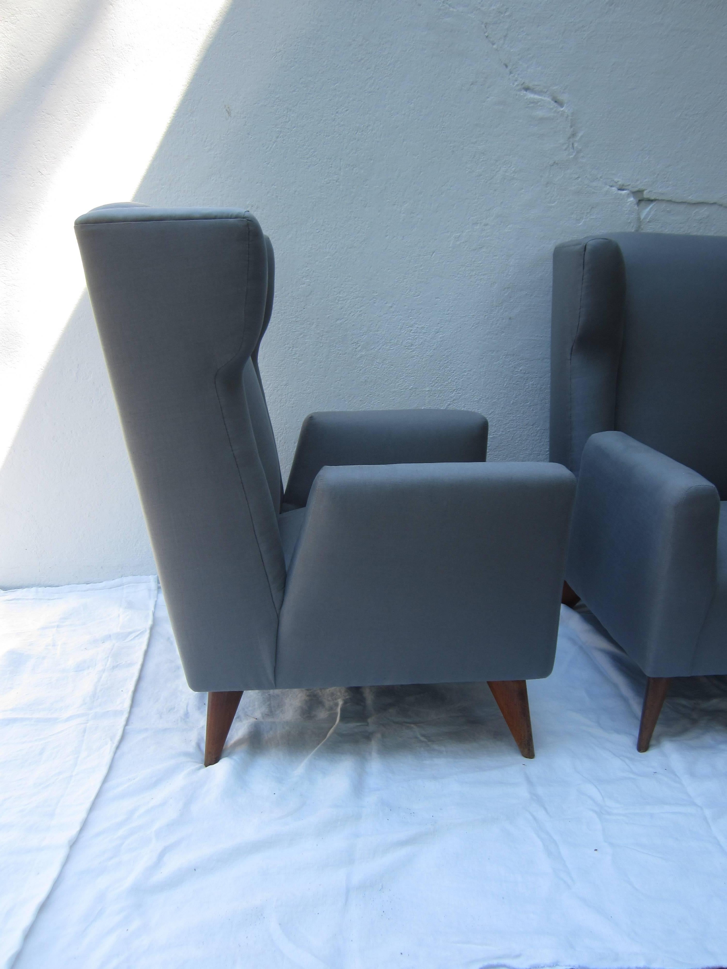 Beautifully made and perfectly scaled modern armchairs made with hand tied copper springs newly refurbished and reupholstered in gray linen.