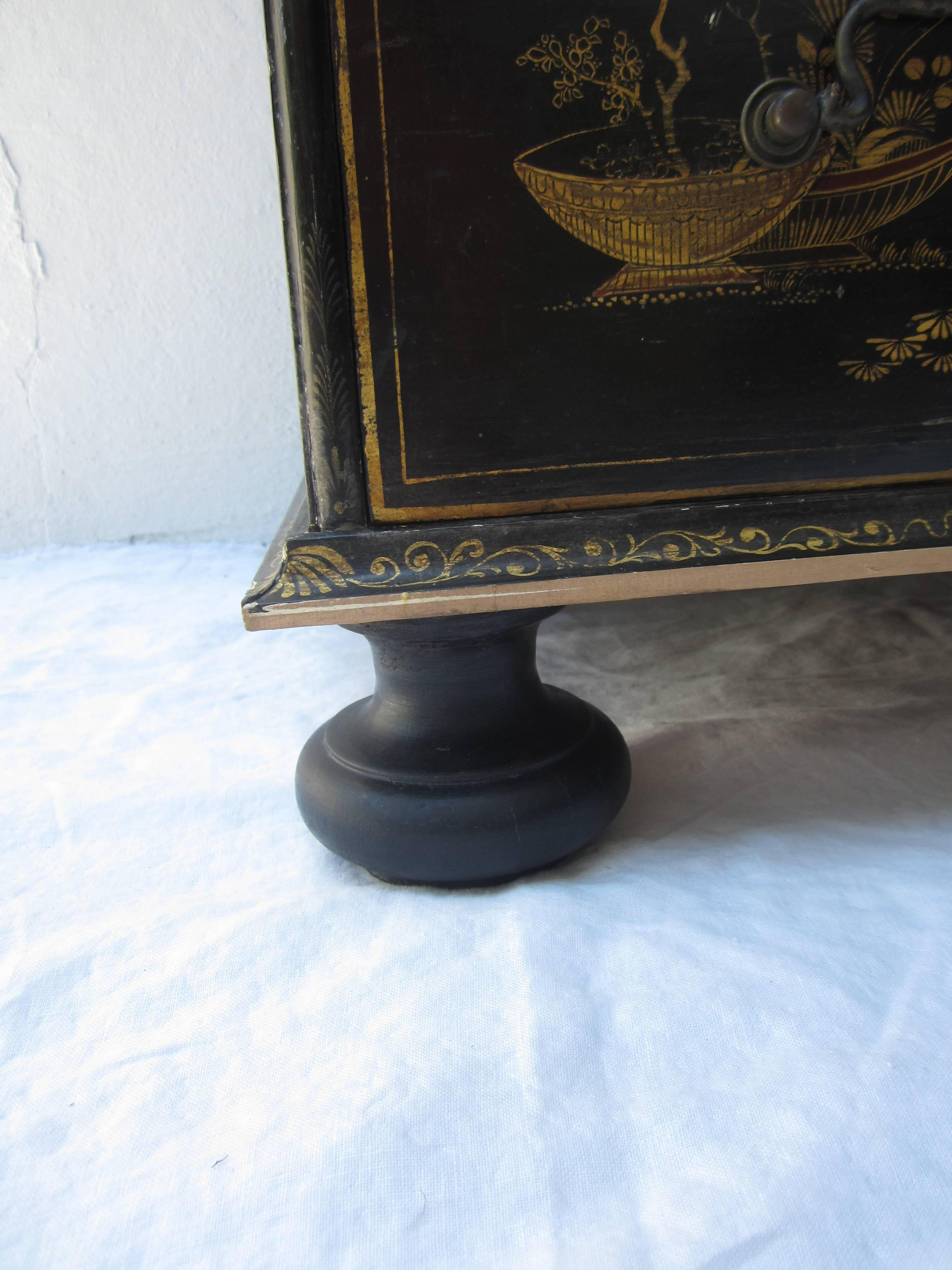 Beautiful chinoiserie style chest of drawers, black with painted detailed scenes with bun feet in the Chippendale style.