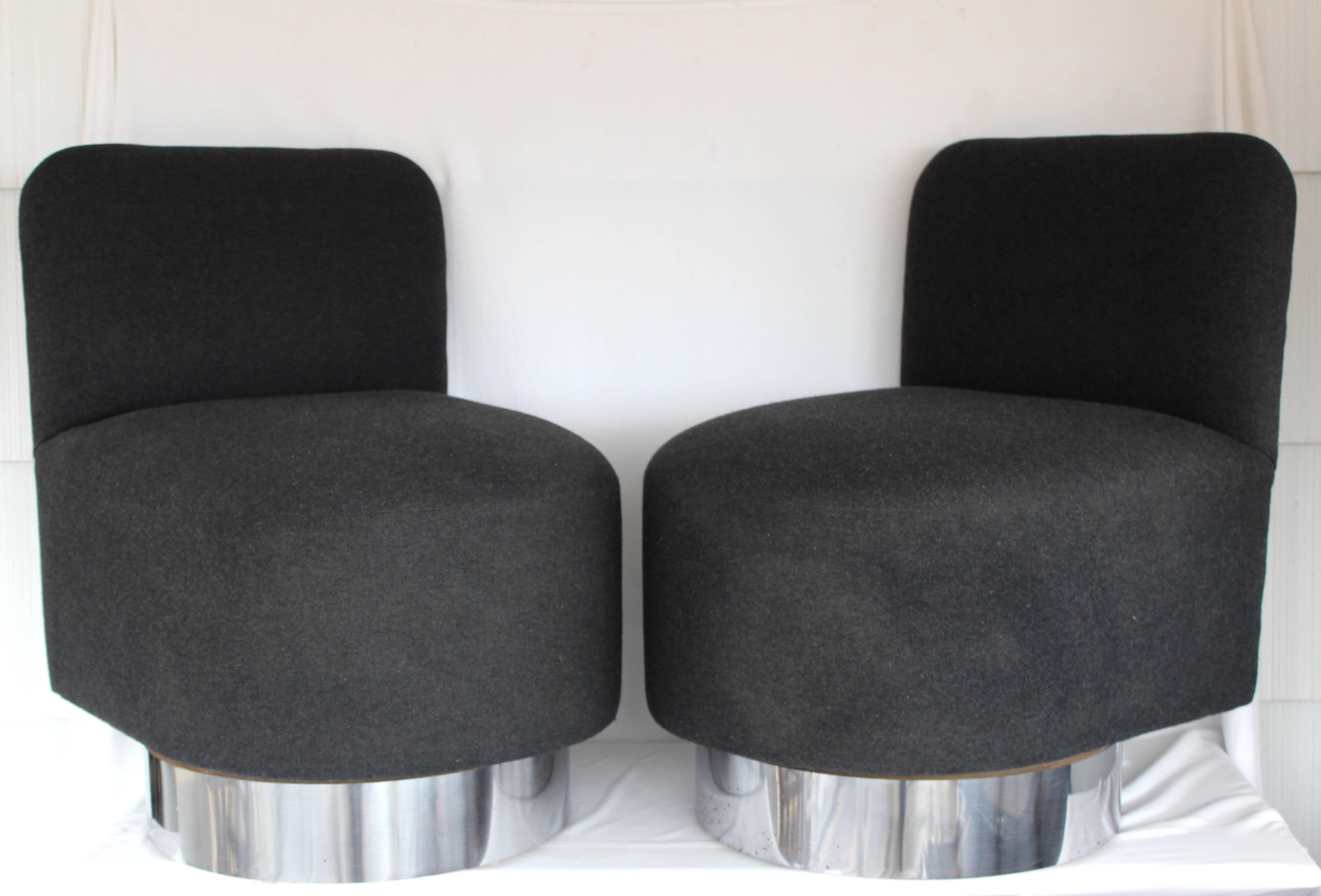 Fabulous and chic pair of slipper chairs with brushed chrome swiveling bases... new grey flannel upholstery. 