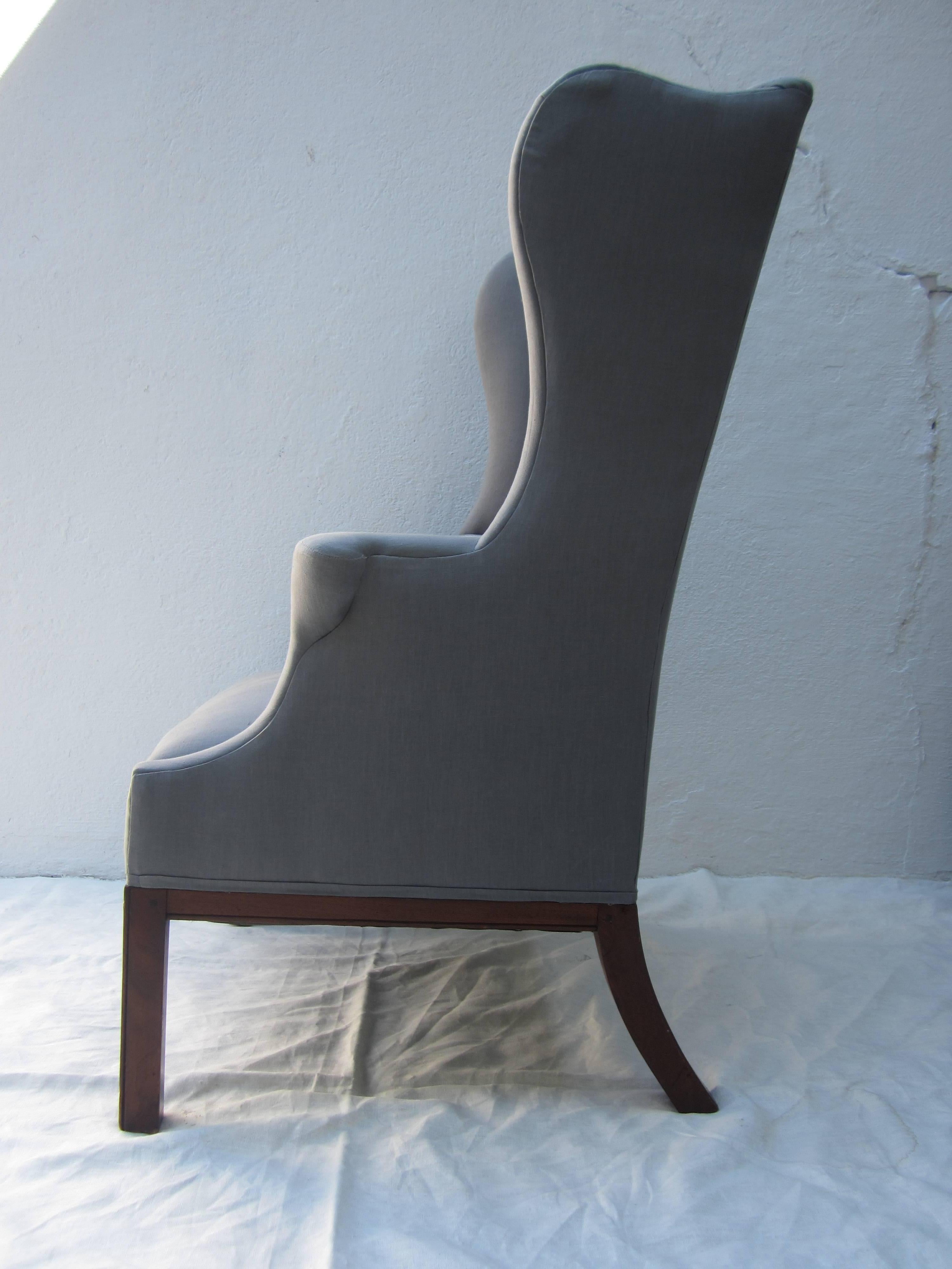 Elegant wingback chair for a desk or where ever newly reupholstered in light gray linen, early 20th century.