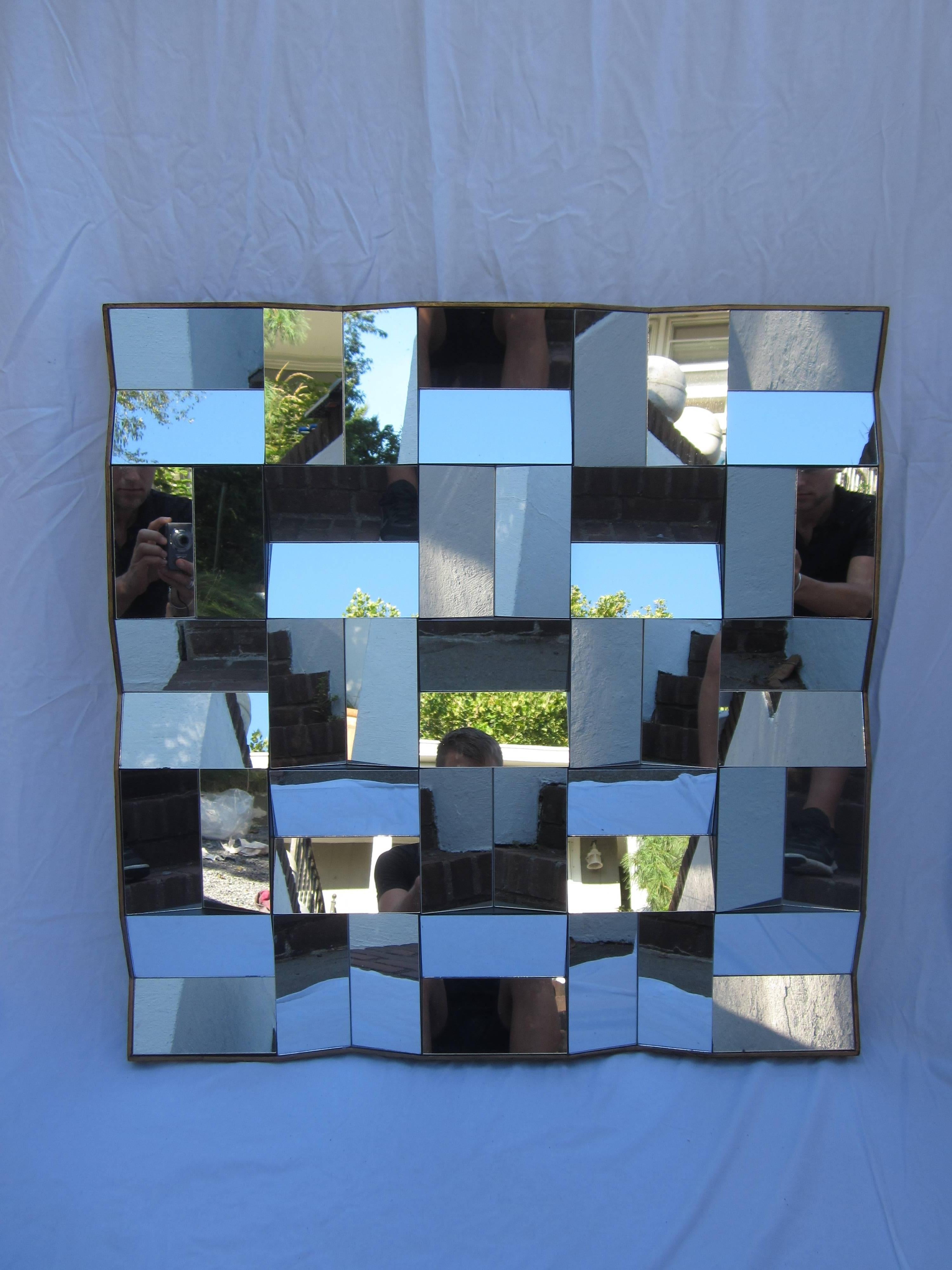 Faceted mirror in the style of Neal Small.