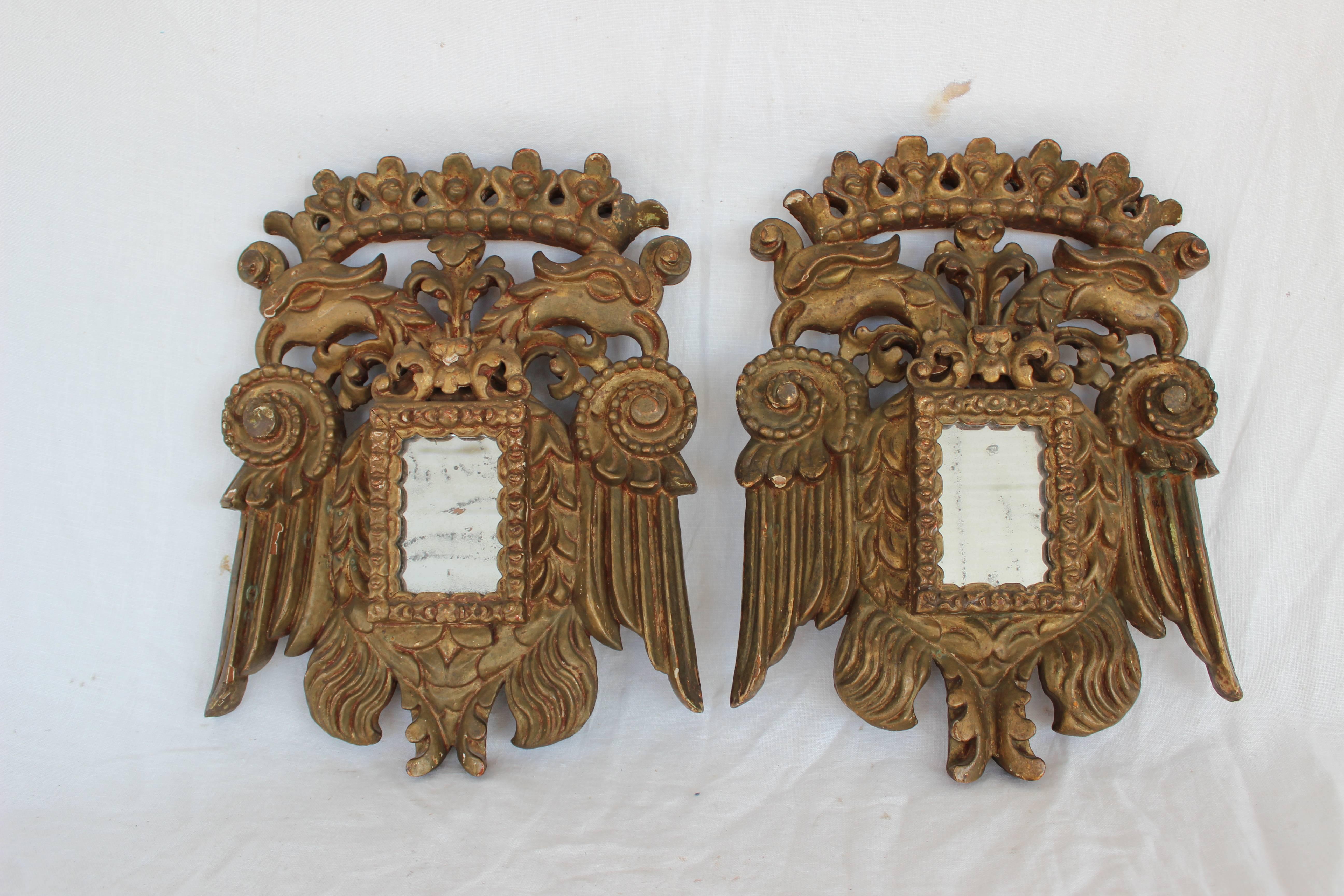 A petit pair early 19th century giltwood mirros.