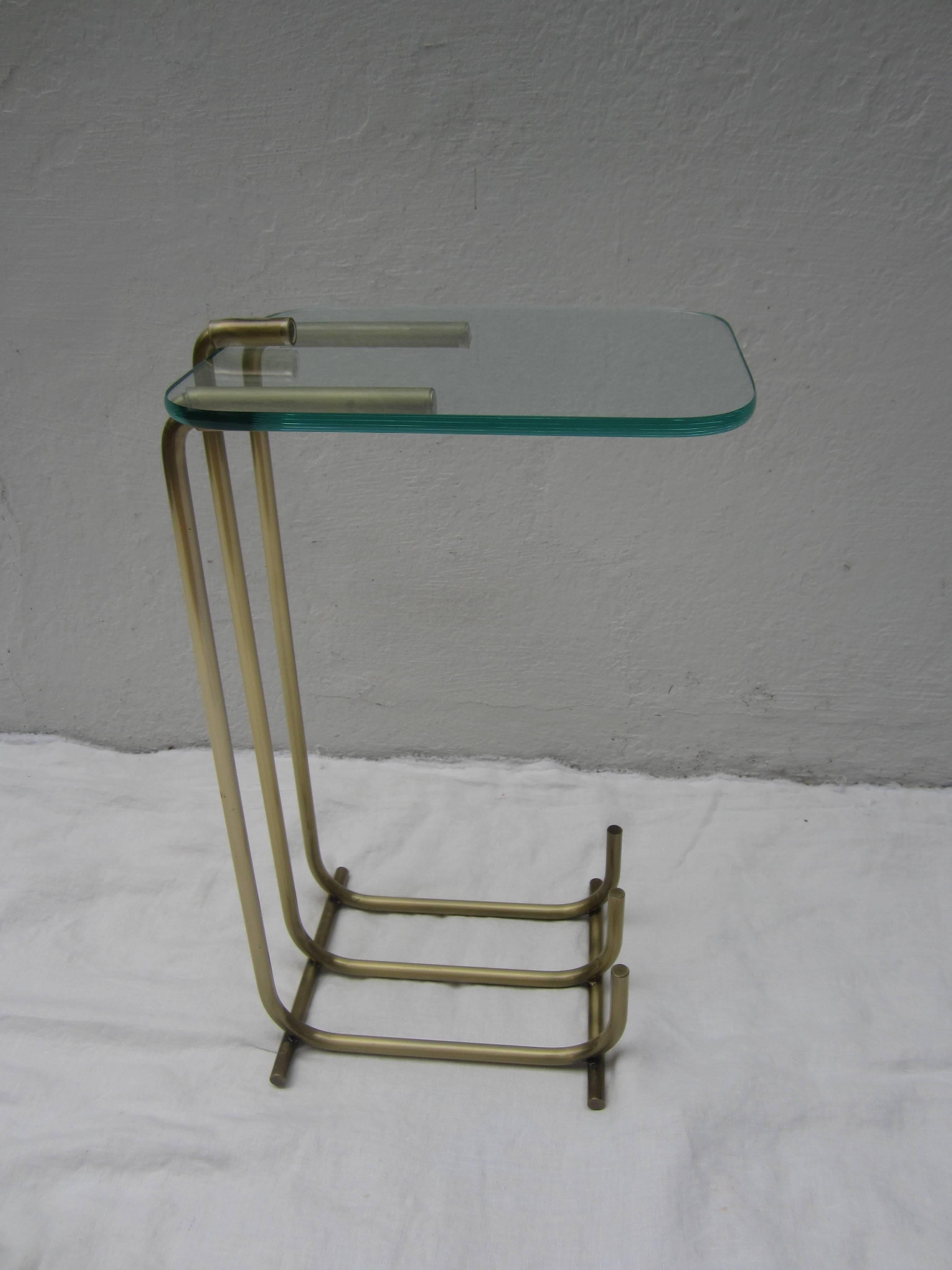 Streamlined metal and glass occasional table.