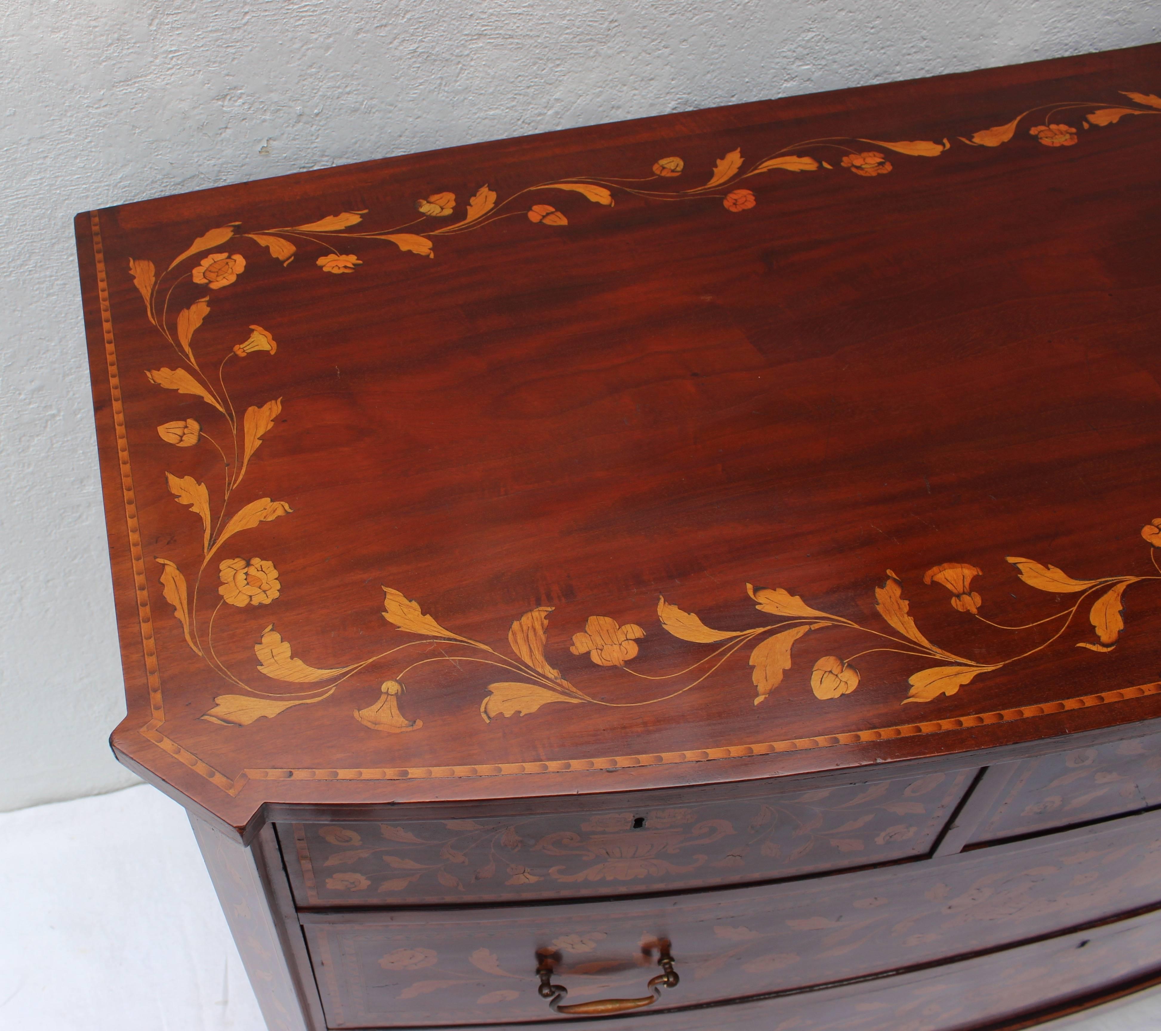 Beautiful intricately inlaid Dutch chest with two large lower drawers and three upper drawers each with lock.