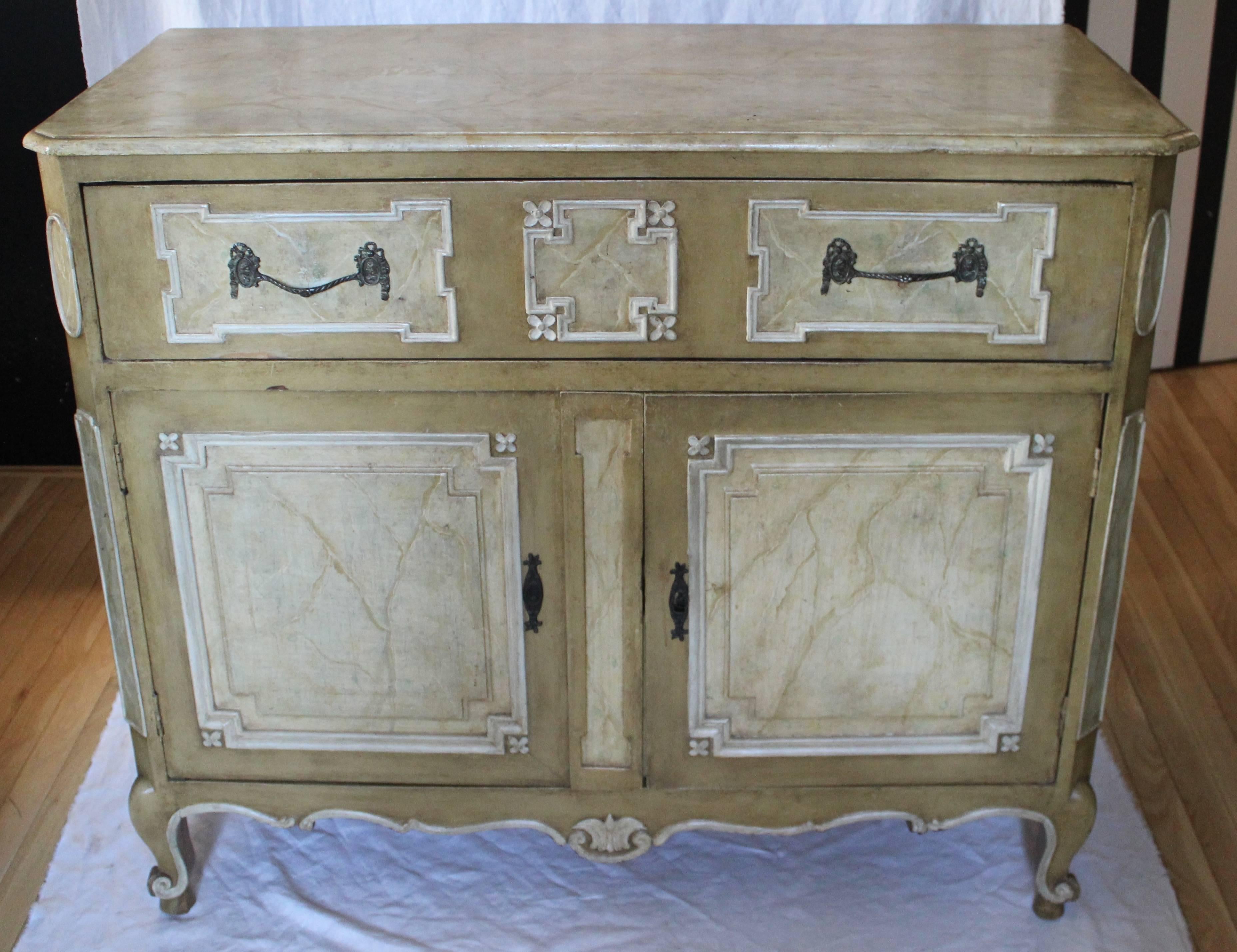 Beautifully painted faux marble carved wood cabinet in the French manner wonderful patina single drawer atop two doors.