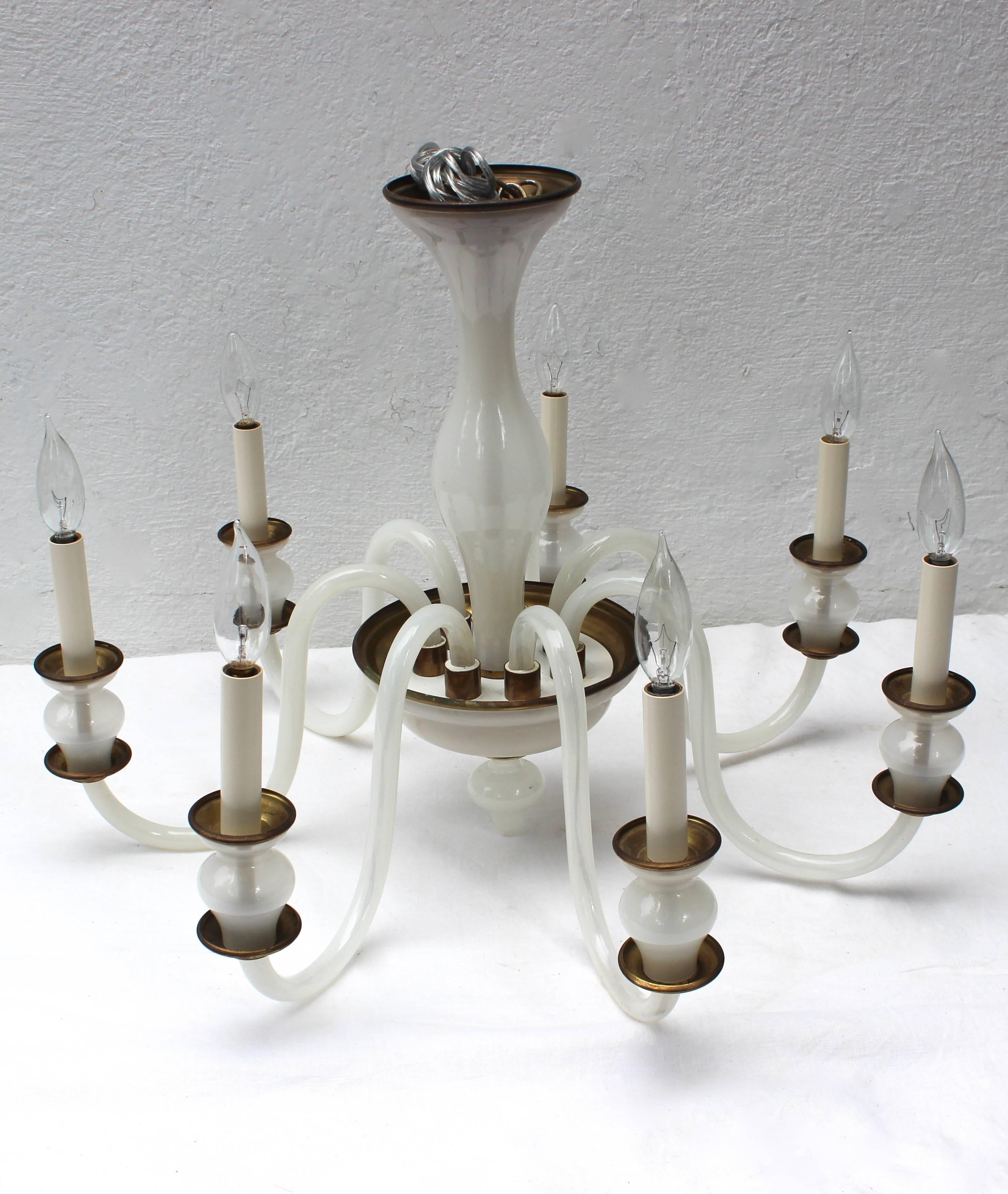 Simple and elegant Murano milk glass and brass seven-arm chandelier. In excellent vintage condition.