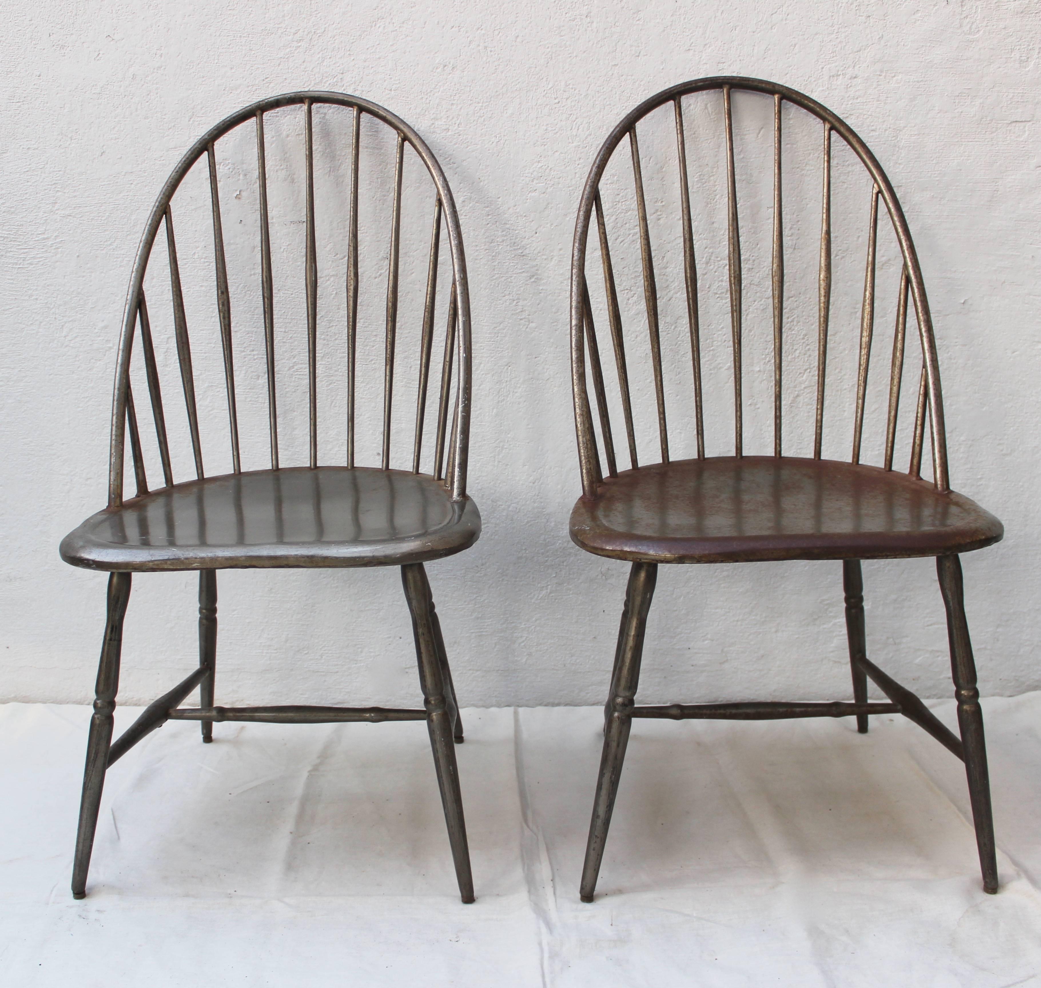 Set of four metal windsor chairs consisting of two armchairs and two side chairs.
Seat height: 18