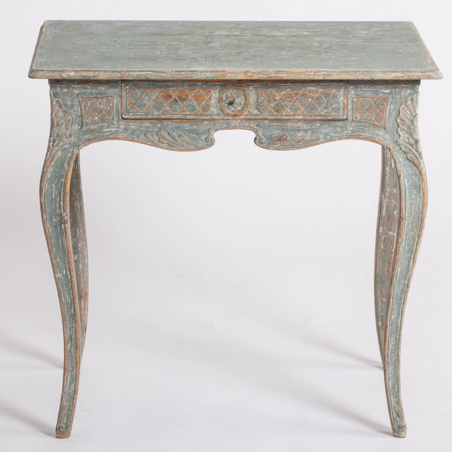This very special console table in original Swedish blue/green paint has beautifully detailed carvings in a basket weave pattern on all sides and a drawer in the front. This is an unusual feature allowing it to be free standing in a room. The