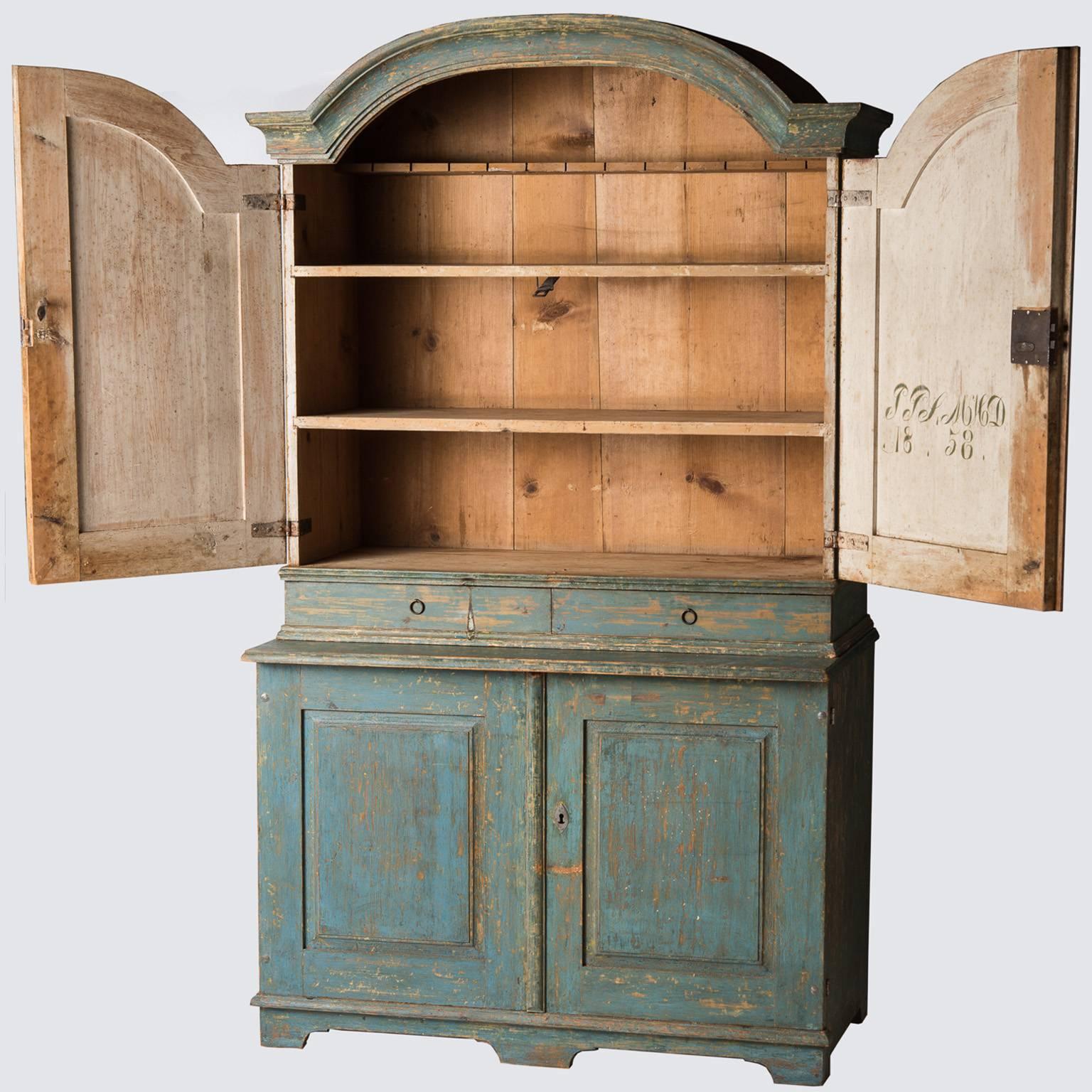 This important cupboard in the Rococo style retains the original blue paint throughout. It has three interior shelves, perfect for storing collections of bowls or china. There are two convenient drawers that could be perfect for silverware and two