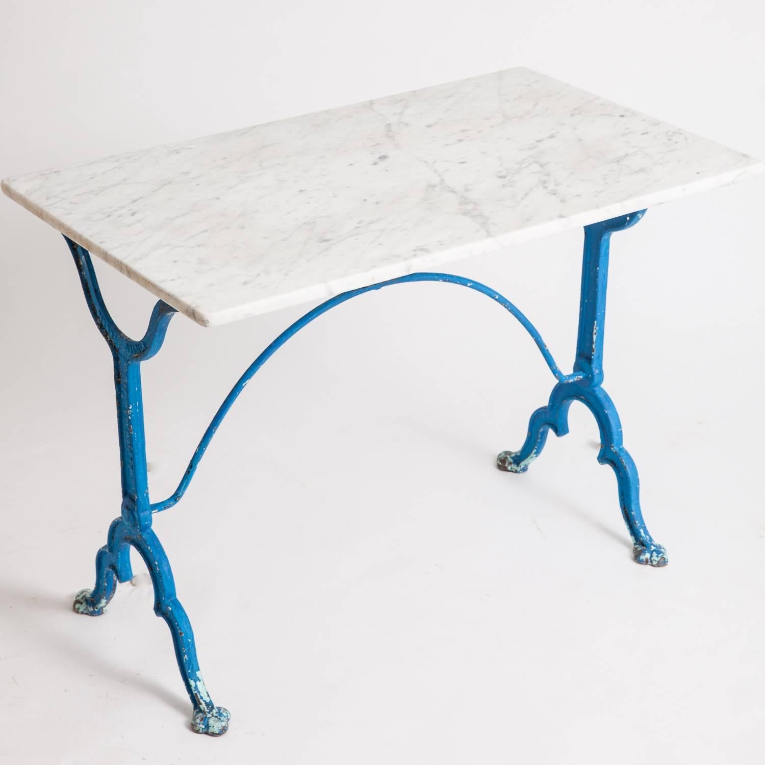 This great cast iron bistro table is marked Pierre Ouvrier, E. Ringlet, Paris. It has traces of wonderful blue paint and a good sized marble-top which is in perfect condition. It dates to circa 1900.