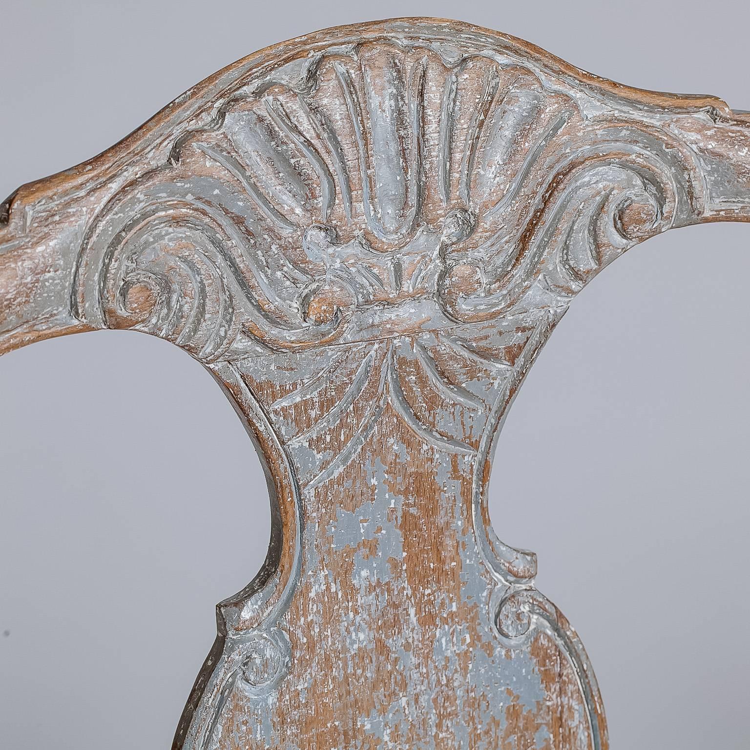 The chairs have the original blue grey patina and beautifully detailed shell carvings on the back and apron that are typical of the Rococo style.