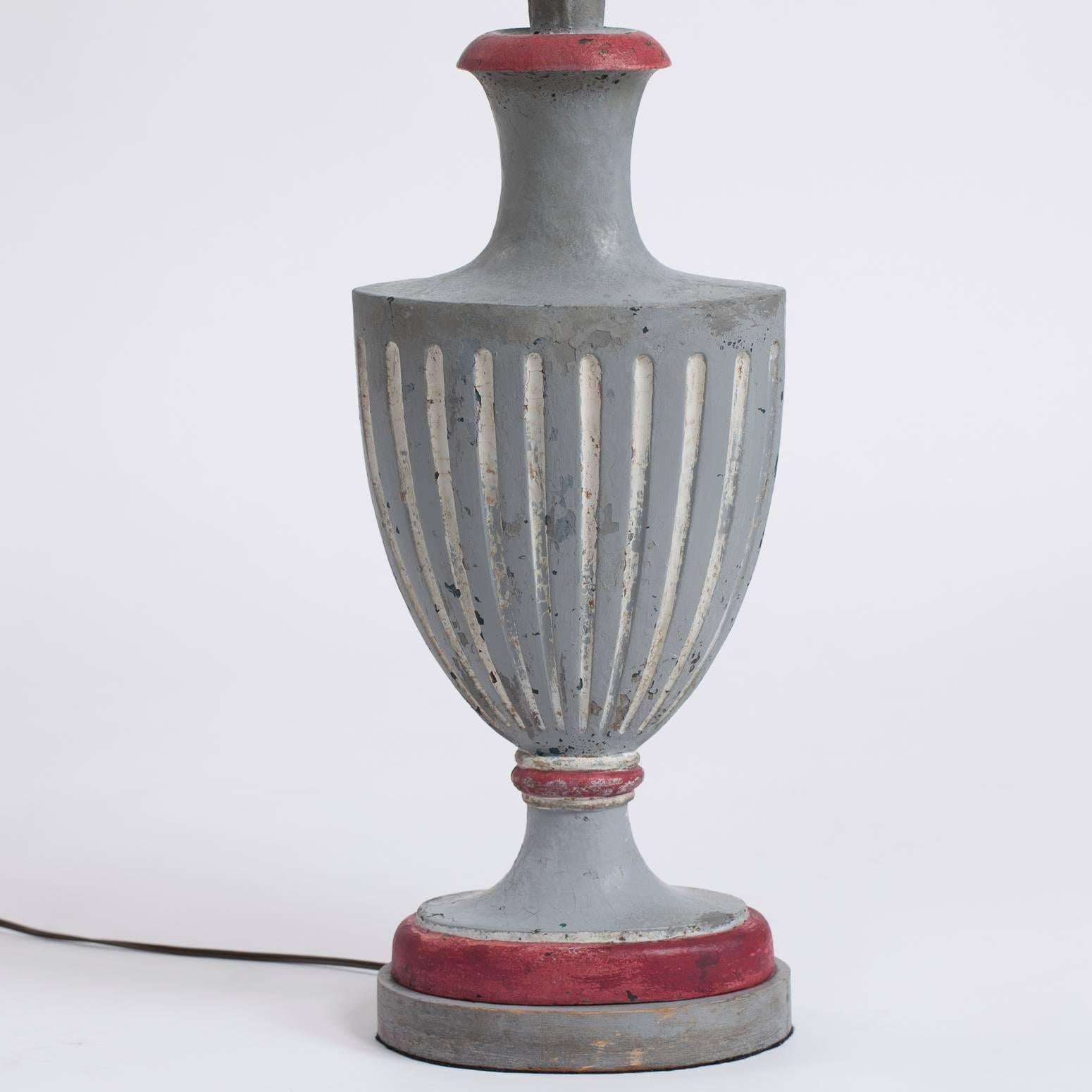 This unusual pair of floor lamps in a fanciful leaf and lily design with grey painted leaves and red berries date from circa 1900. The bases in the form of classical urns echo the red and grey of the flowers and the matching finials. The custom oval