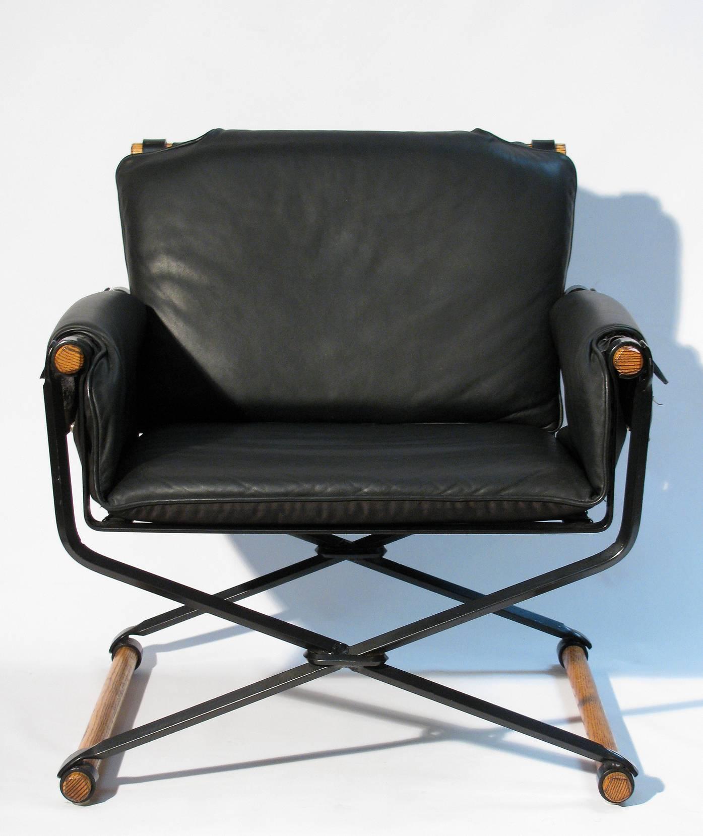 A lounge chair and ottoman, wrought iron X fame with oak stretchers and loose cushions that tie with straps onto the frame. In the campaign tradition by Los Angeles based American architect and designer, Cleo Baldon (1927 - 2014) for Terra