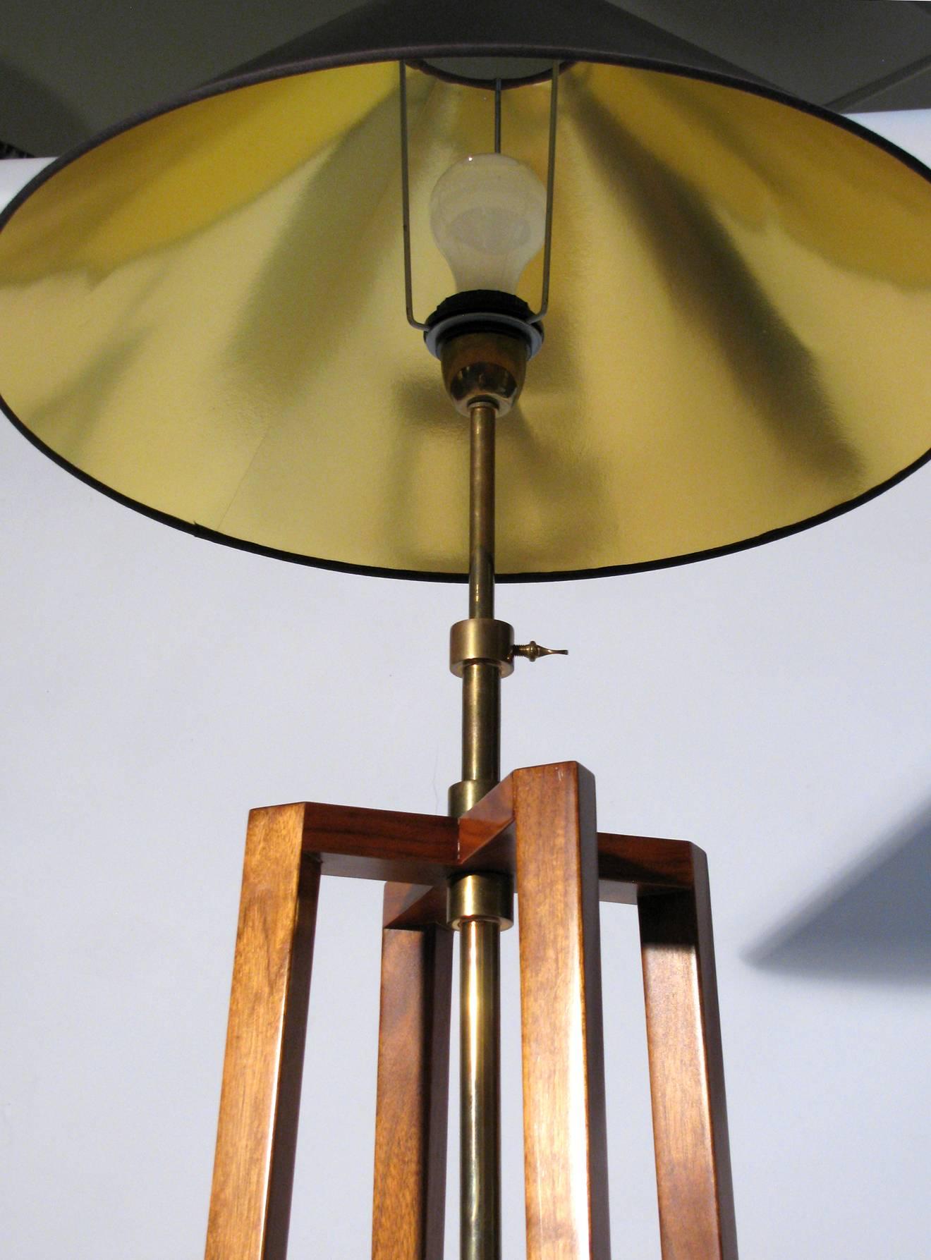 A floor lamp from the Mirak Collection, "Chevalet." The base is mahogany with brass hardware. Height is adjustable 55 inches to 62 inches. Gold foil paper shade is included and measures 20 inches diameter, 9 inches height, 4 inch top