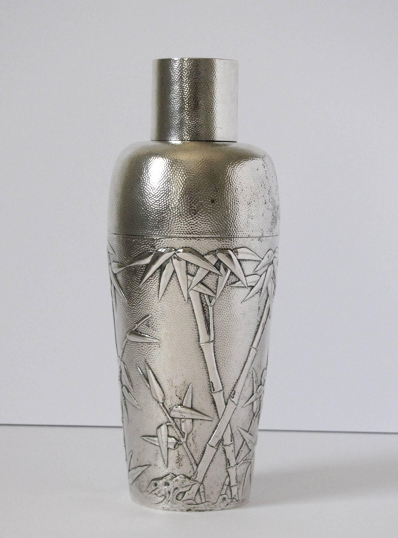 A rare and important Chinese export silver cocktail shaker by Hung Chong, Canton or Shanghai. The finely detailed embossed bamboo decoration, with the detachable strainer and cap, engraved R S R monogram to the cap and 'Pay Department U.S.S.