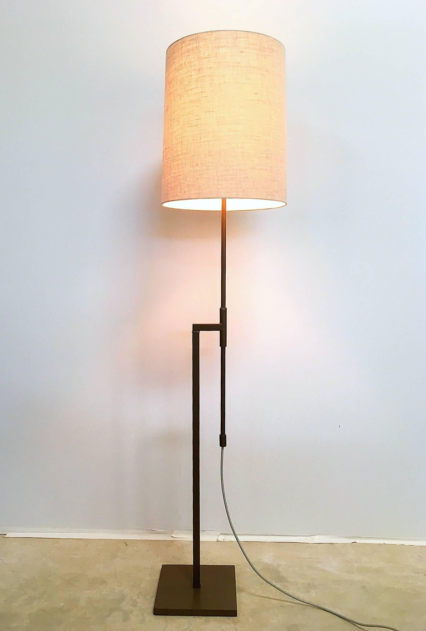 A modernist adjustable floor lamp by Laurel with an antique bronze powder coat finish. The cantilevered square tube stand connects a round tube pole that adjusts in height (45 - 67 inches), the whole rests on a square weighted base. Included is a
