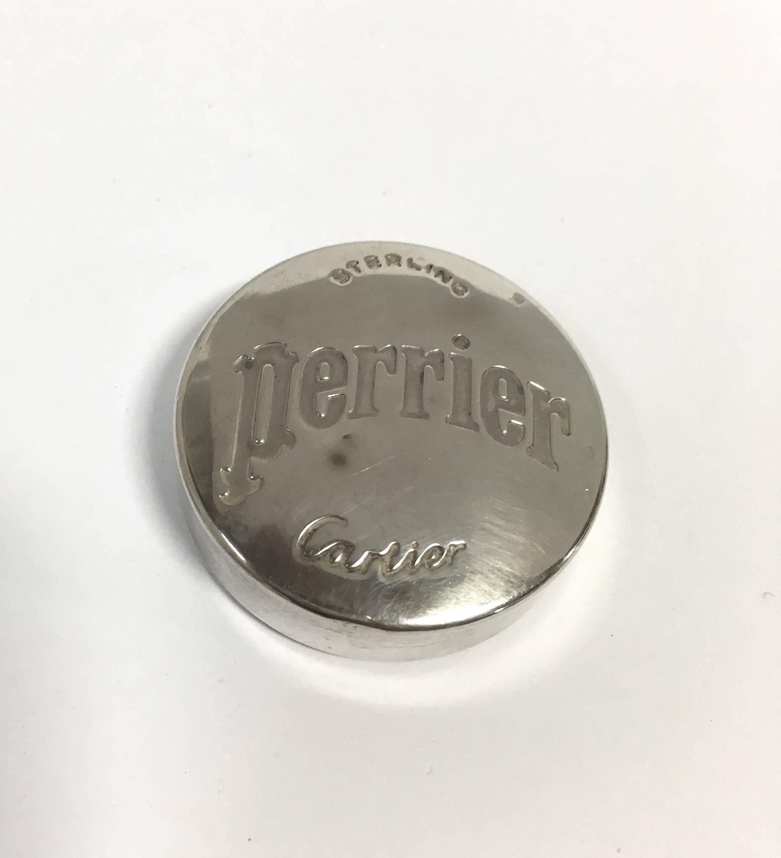 Chic bottle opener and cap set in sterling silver by Cartier Paris, carrying both the Perrier and Cartier branding. Neither of these brands needs an introduction. What is perhaps most peculiar about the item is it's collaborative nature. The bottle
