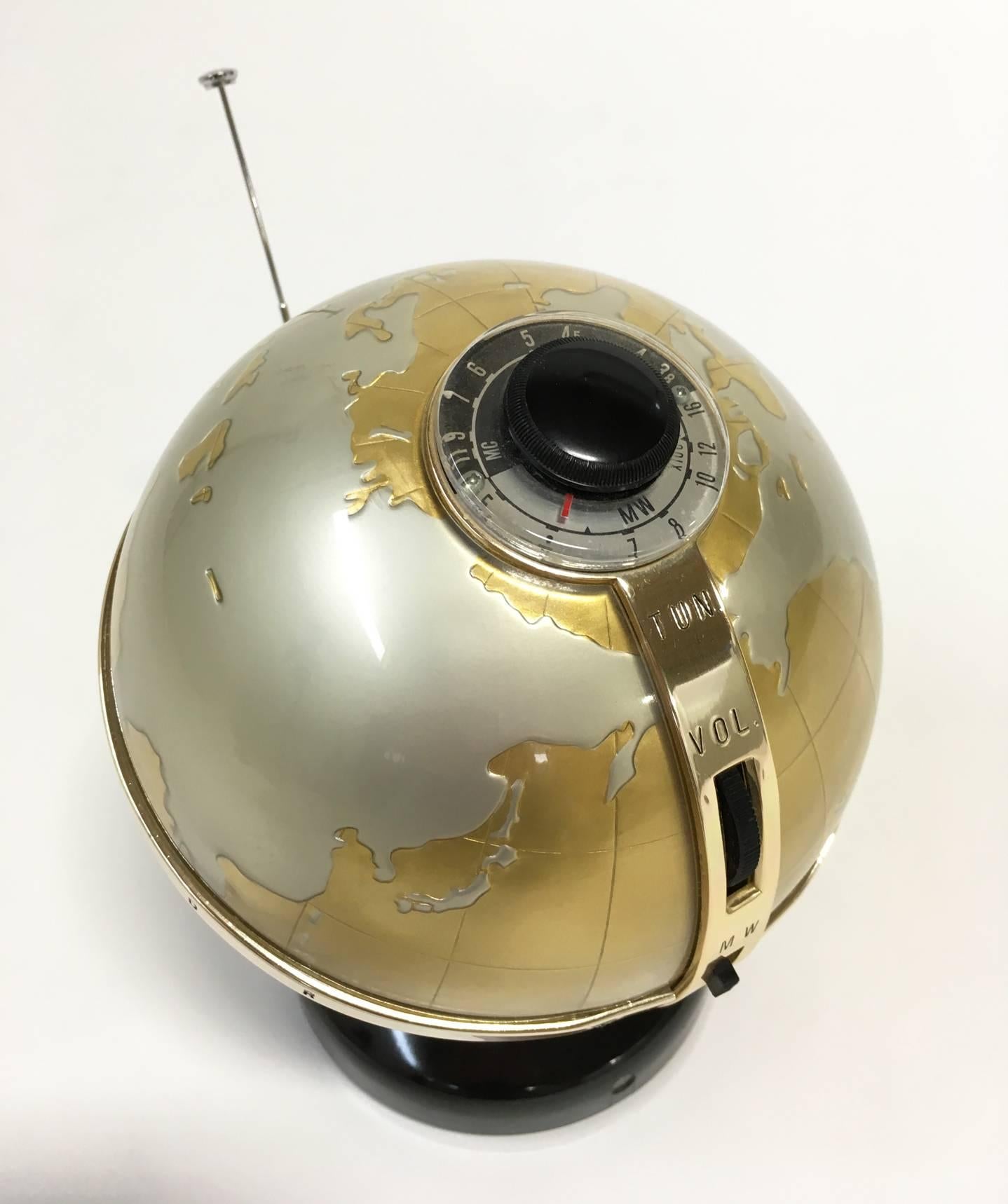 A rare vintage modern vista model NTR-6G globe transistor radio. Made in Japan, circa 1960. The tuner control dial is on the top of the globe, at the north pole. Connected is the metal band that extends south and includes controls for on/off,