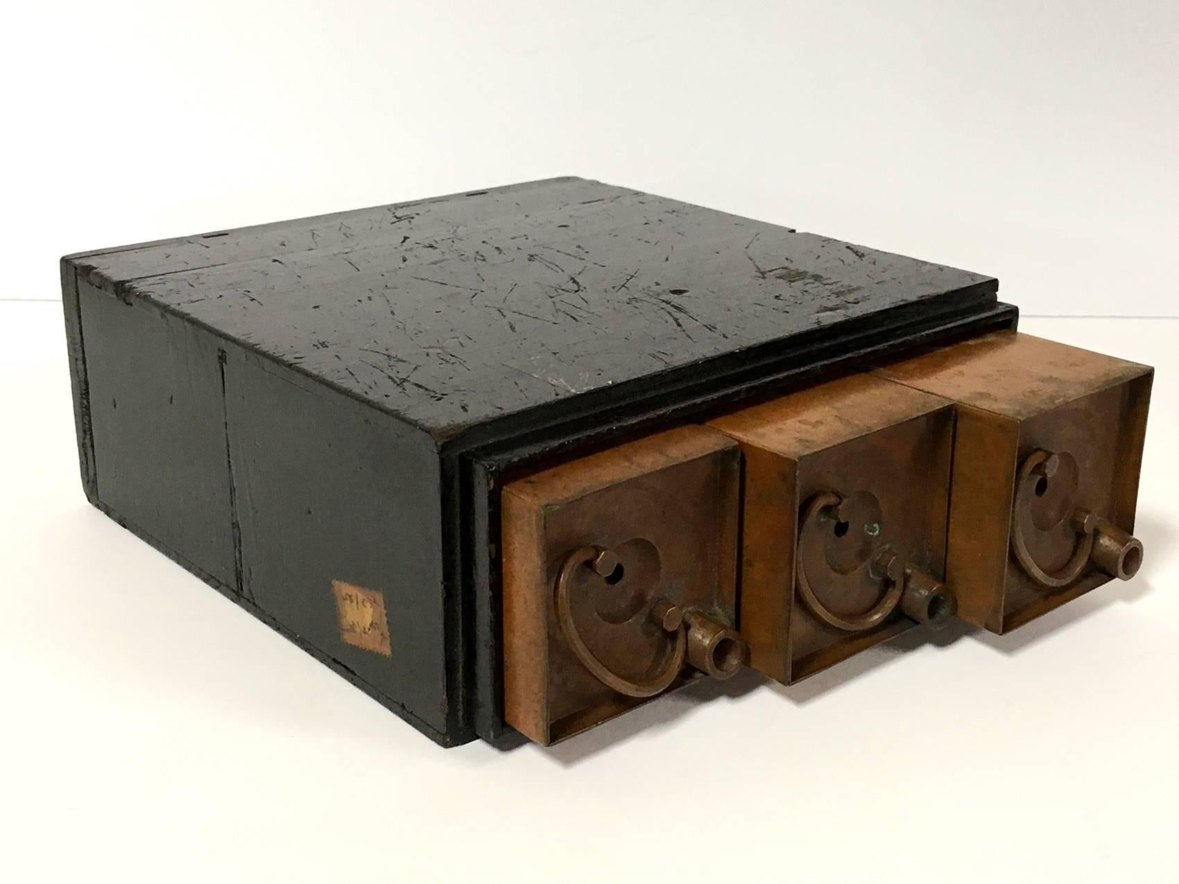 A rare set of three Japanese Meiji period copper containers, rectangular in form, fitted for a black lacquer wood box. The copper containers each measure; 8.5 inches tall, 2.5 inches width, 2.5 inches deep. The wood box measures; 8.5 inches H, 8.25