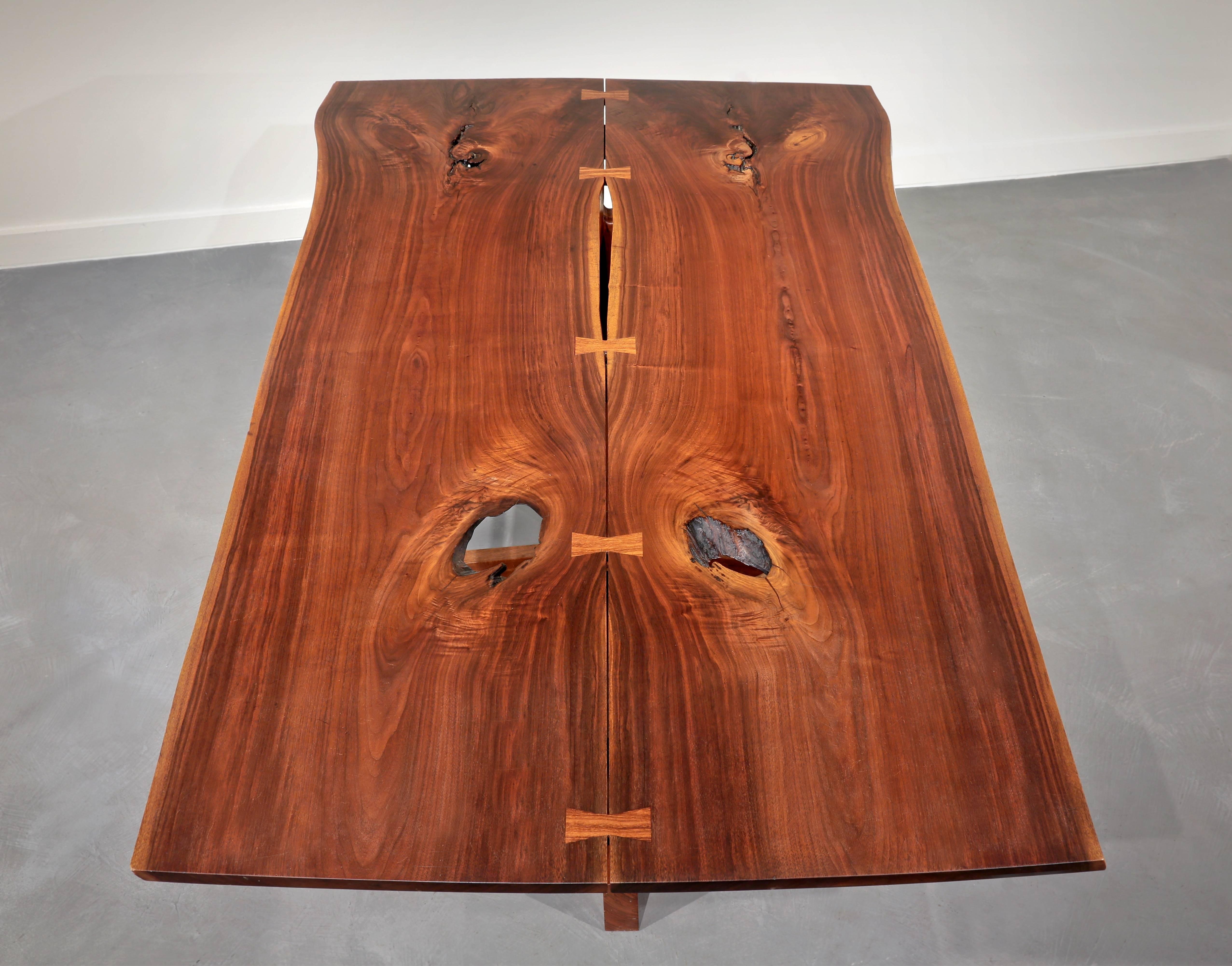 American black walnut 8.5’ Conoid dining table, with highly figured two-board book-matched top, two free sap edges and five rosewood butterflies. 
Note: Butterflies show up as blond due to the flash, but are actually quite dark.
