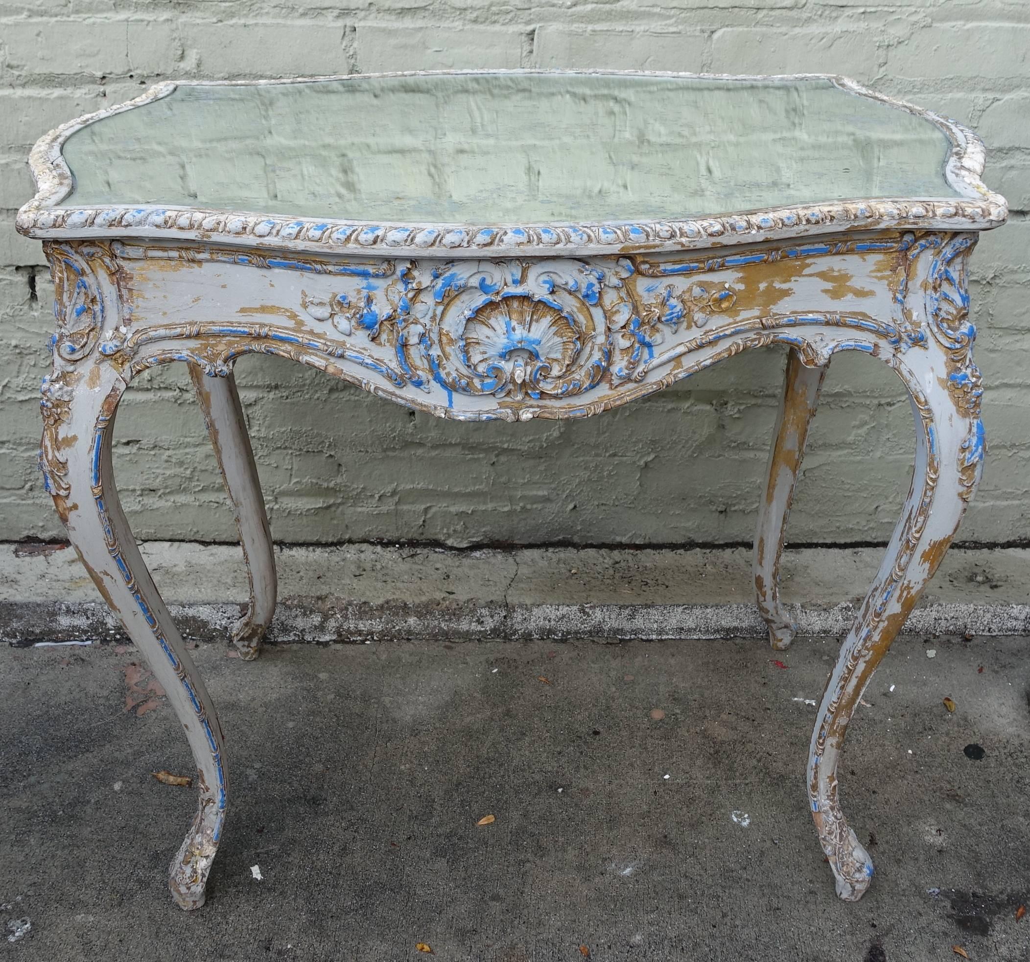 19th century French painted Louis XV style table standing on four cabriole legs. Carved center cartouche on the apron of the table. Antique mirrored top.