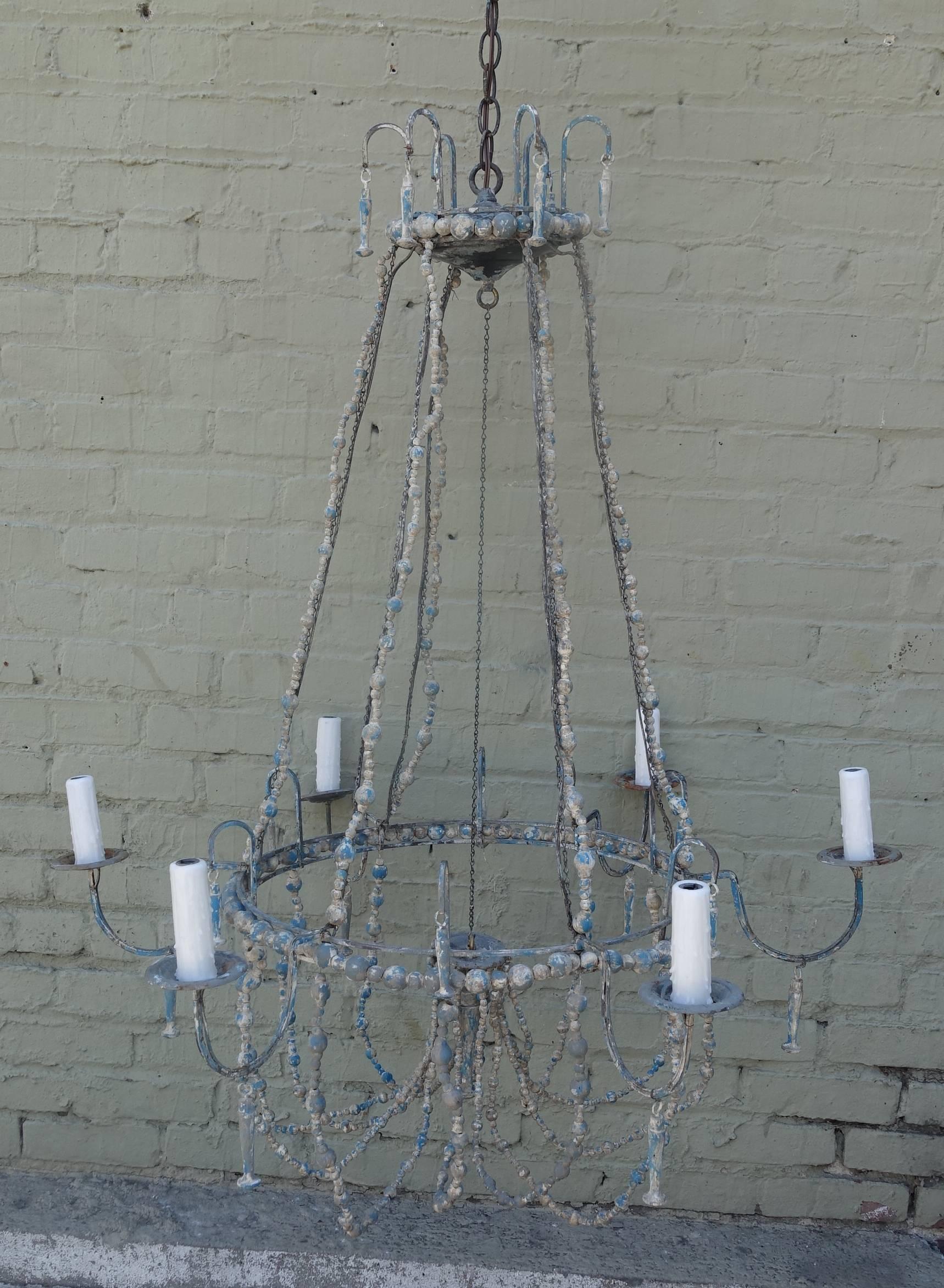 Six-light Italian painted chandelier with swags of wood beads throughout. Drip wax candle covers. Newly wired and in working condition.