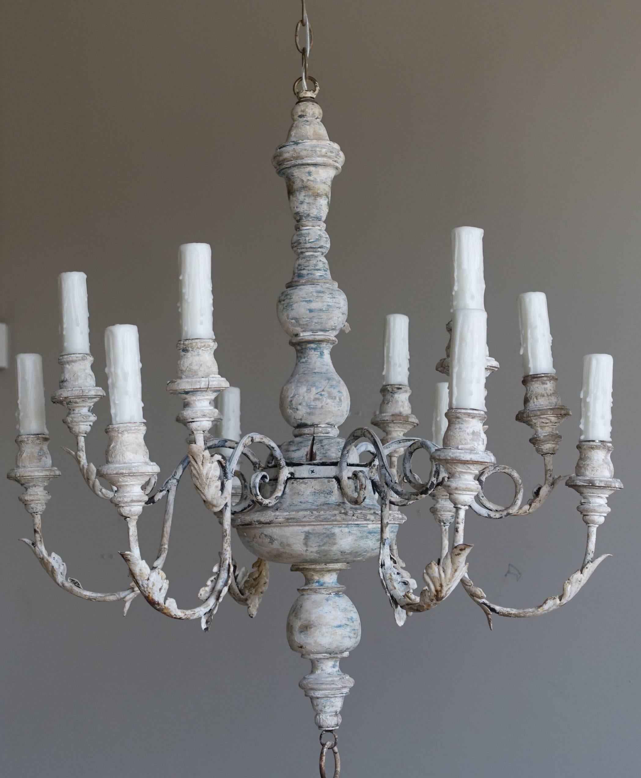 Italian twelve-light wood and iron chandelier newly wired with drip wax cream candle covers. Chandelier includes 40
