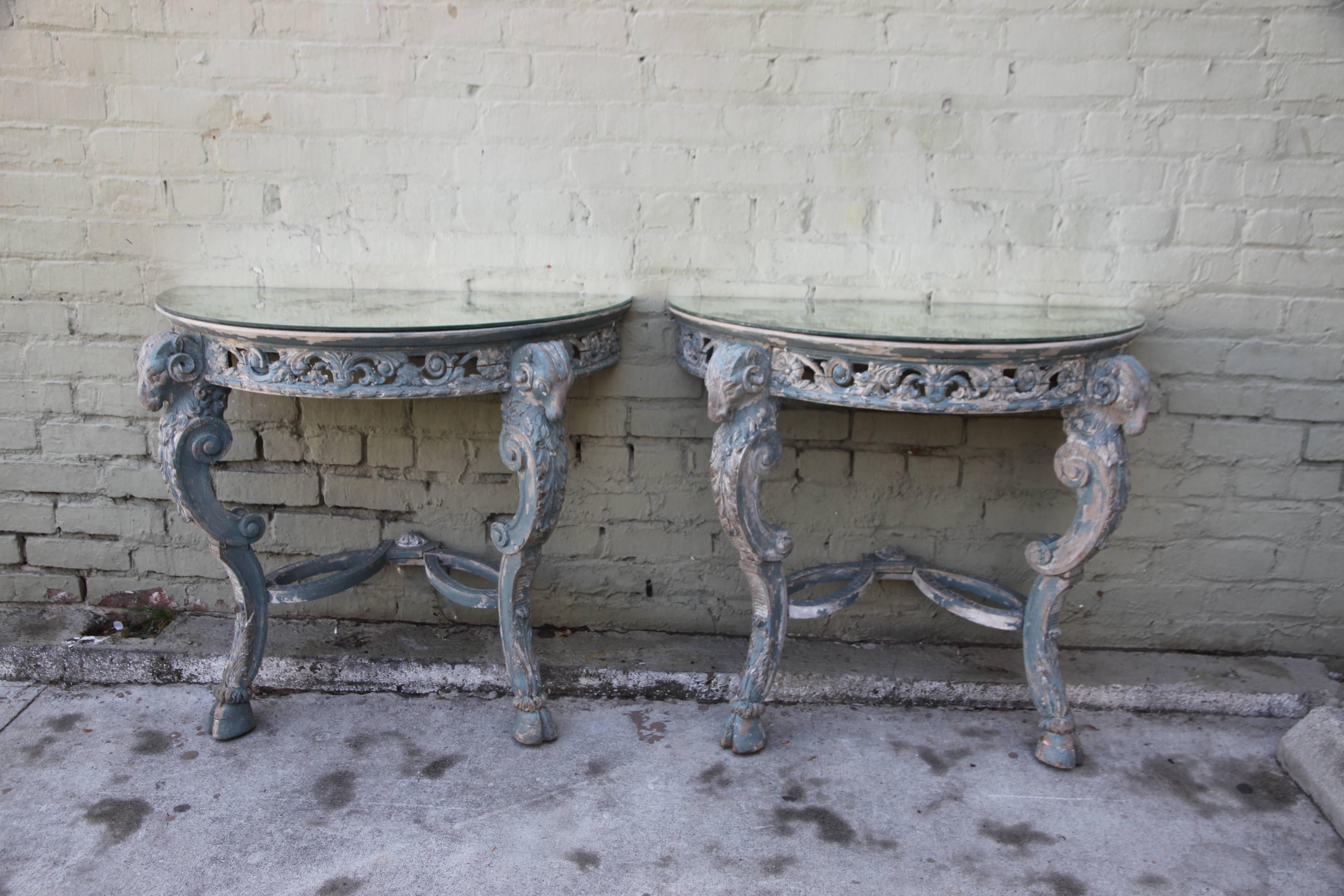 Single French carved ram's head consoles painted with antiqued mirrored tops.