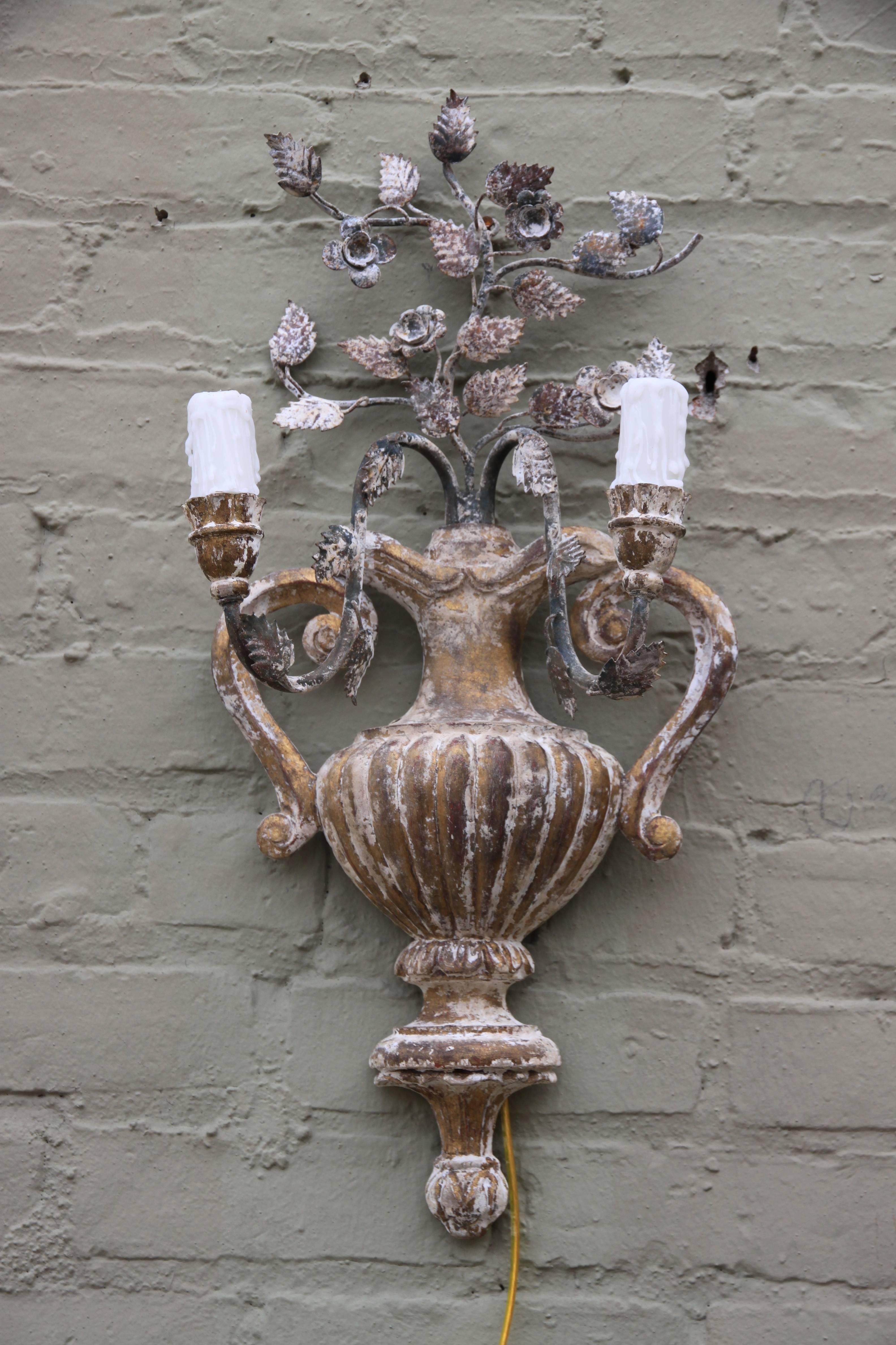 Pair of Italian two-light carved wood urn sconces with iron flowers and leaves. Newly wired and ready to install with wax candle sleeves.