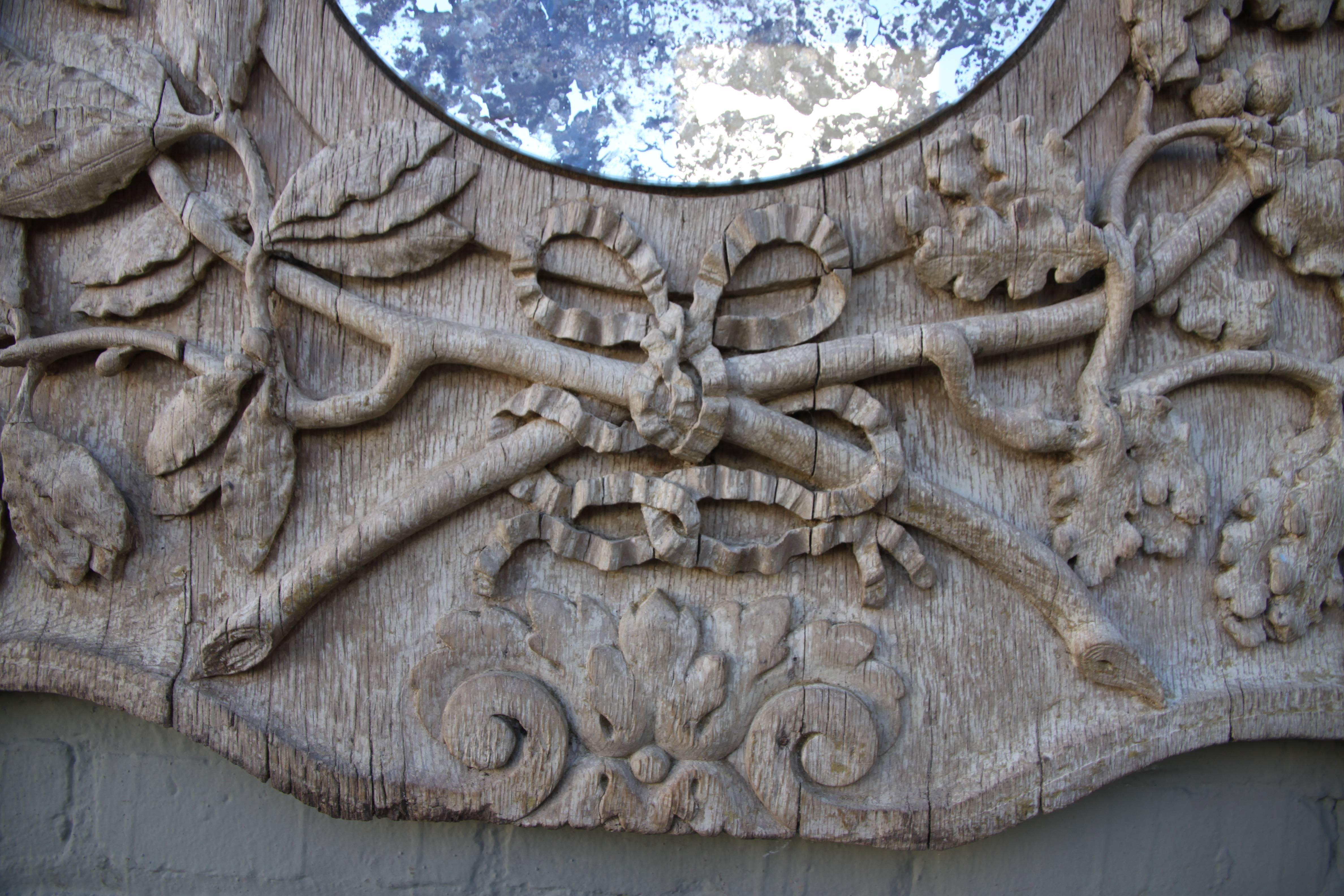 19th century Italian mirror with hand-carved oak leaves throughout. Mirror has antiqued glass.
