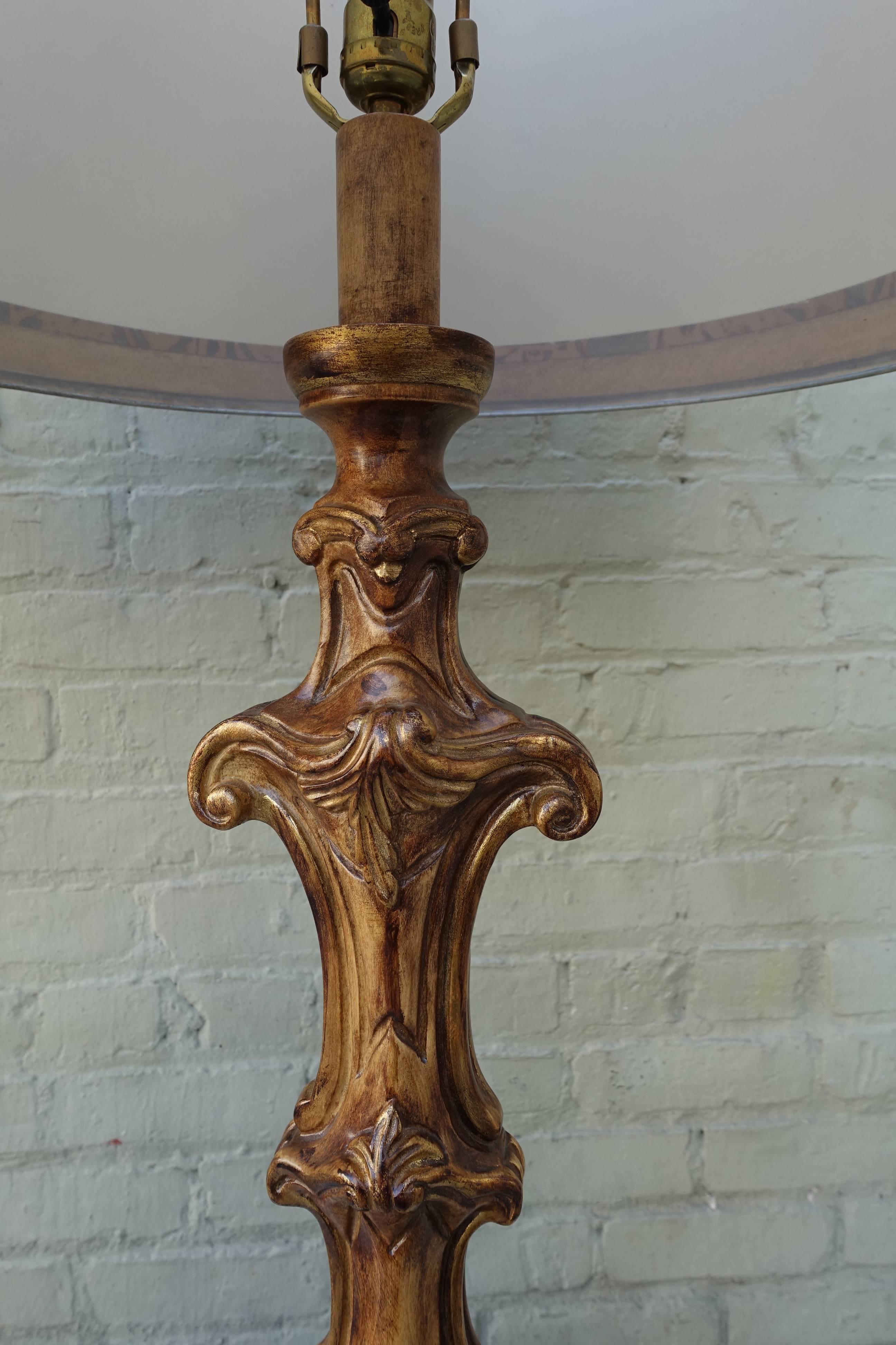 Pair of carved wood painted and parcel-gilt Italian candlesticks that have been wired into contemporary lamps. The lamps are crowned by custom hand-painted parchment shades. They are newly wired with US sockets and are ready to install. Measures: