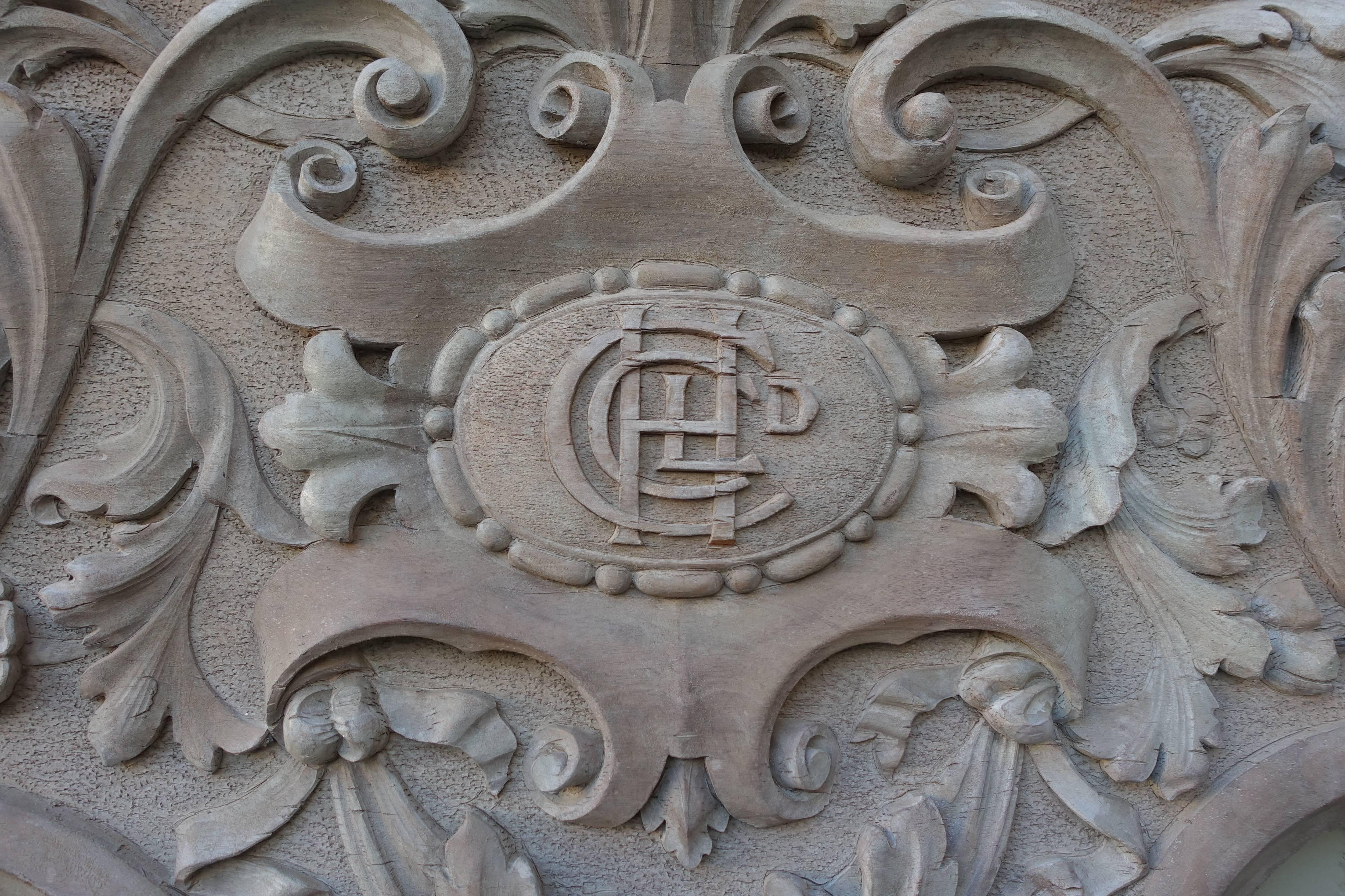 Finely carved wood painted carving, circa 1900 with centre cartouche and monogram. There are a pair of griffins flanking either side of the cartouch with swirling acanthus leaves throughout. Soft grey painted finish.