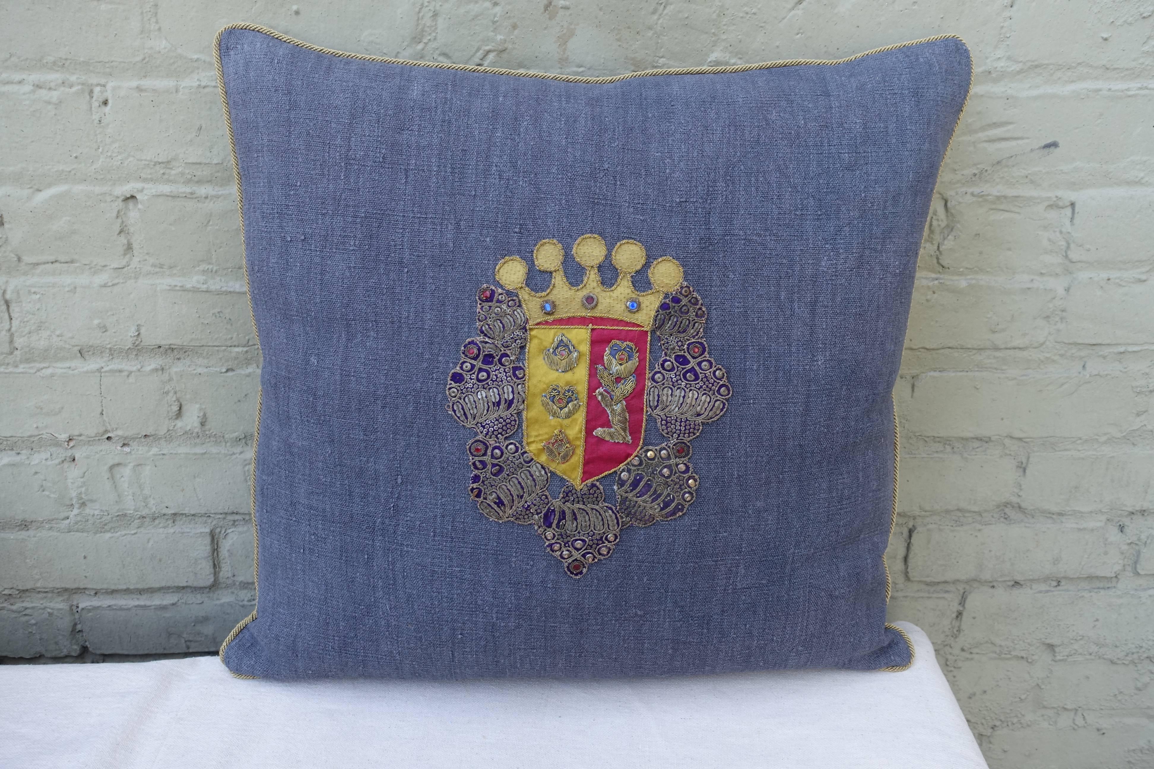 Pair of 19th century metallic and silk coat of arms applique´d on antique home spun linen and finished with metallic gold cording around the edges. Down inserts.