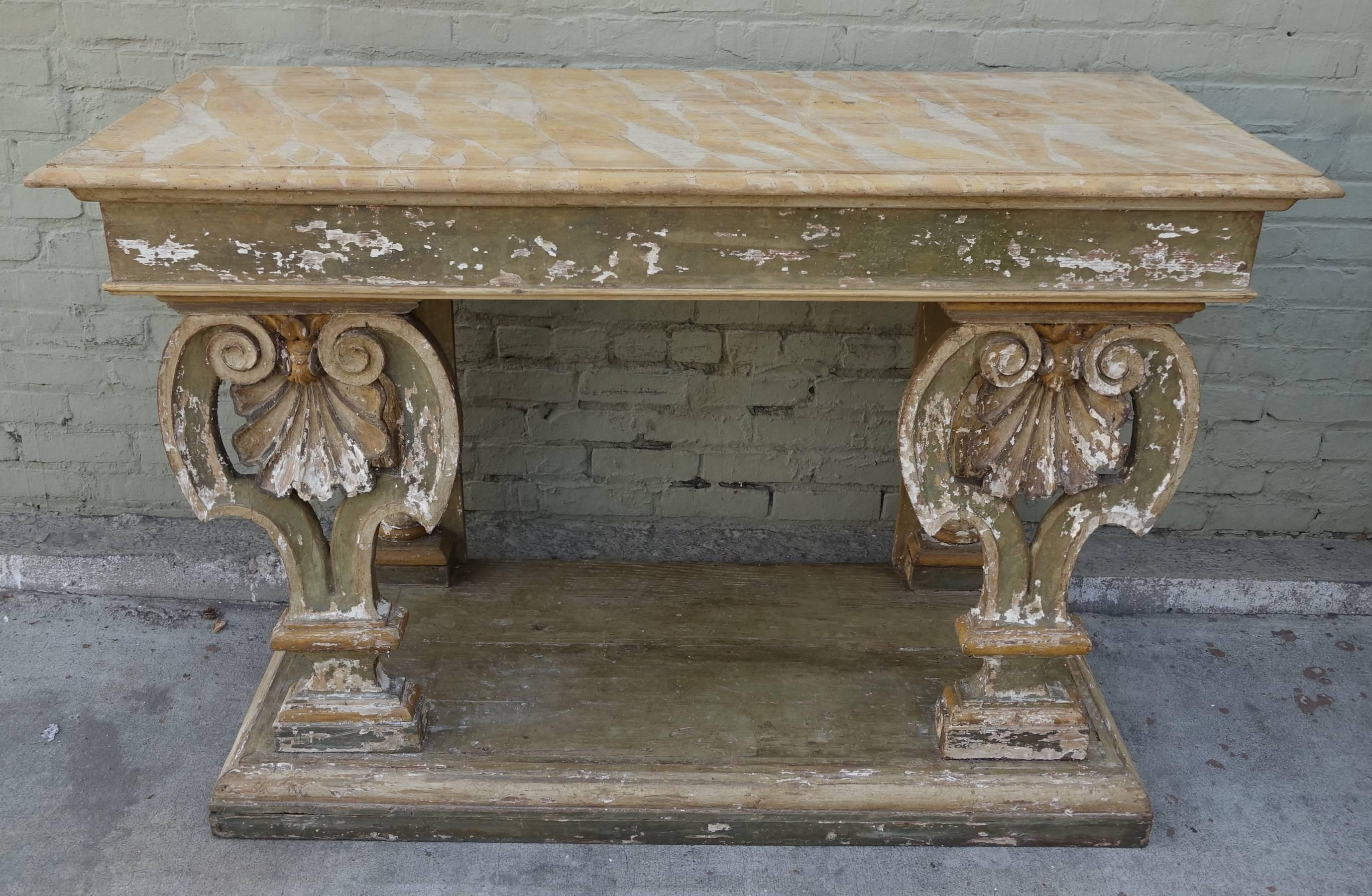 Pair of 19th century painted Italian consoles the shaped rectangular faux marble top above gilt lyre from supports resting on a lower shelf.