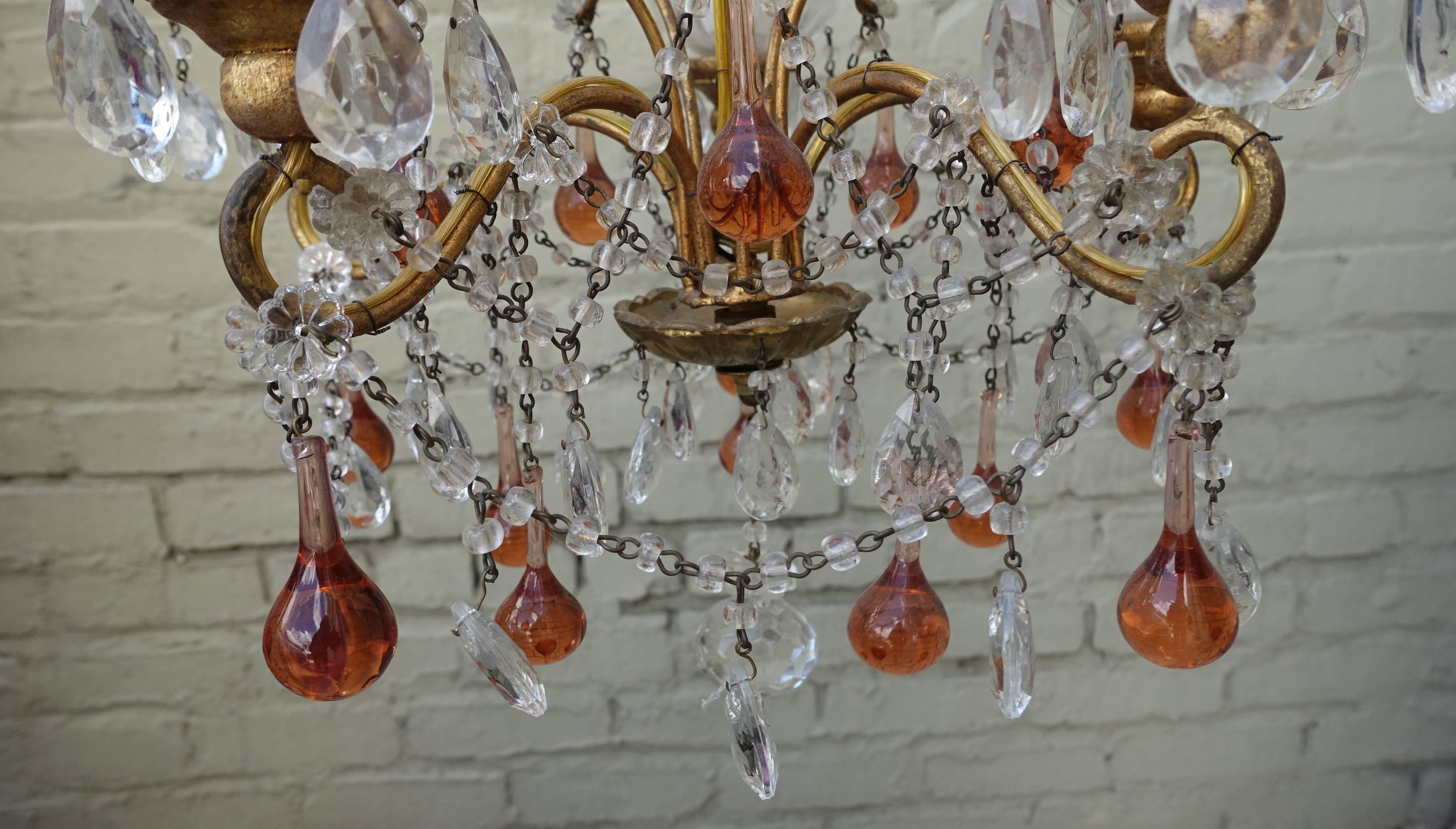 French gilt metal crystal beaded five-light chandelier with light amber drops. This fixture is adorned with garlands of macaroni beads, faceted tear drop crystals, and finished with a faceted crystal ball. Newly rewired with chain and canopy