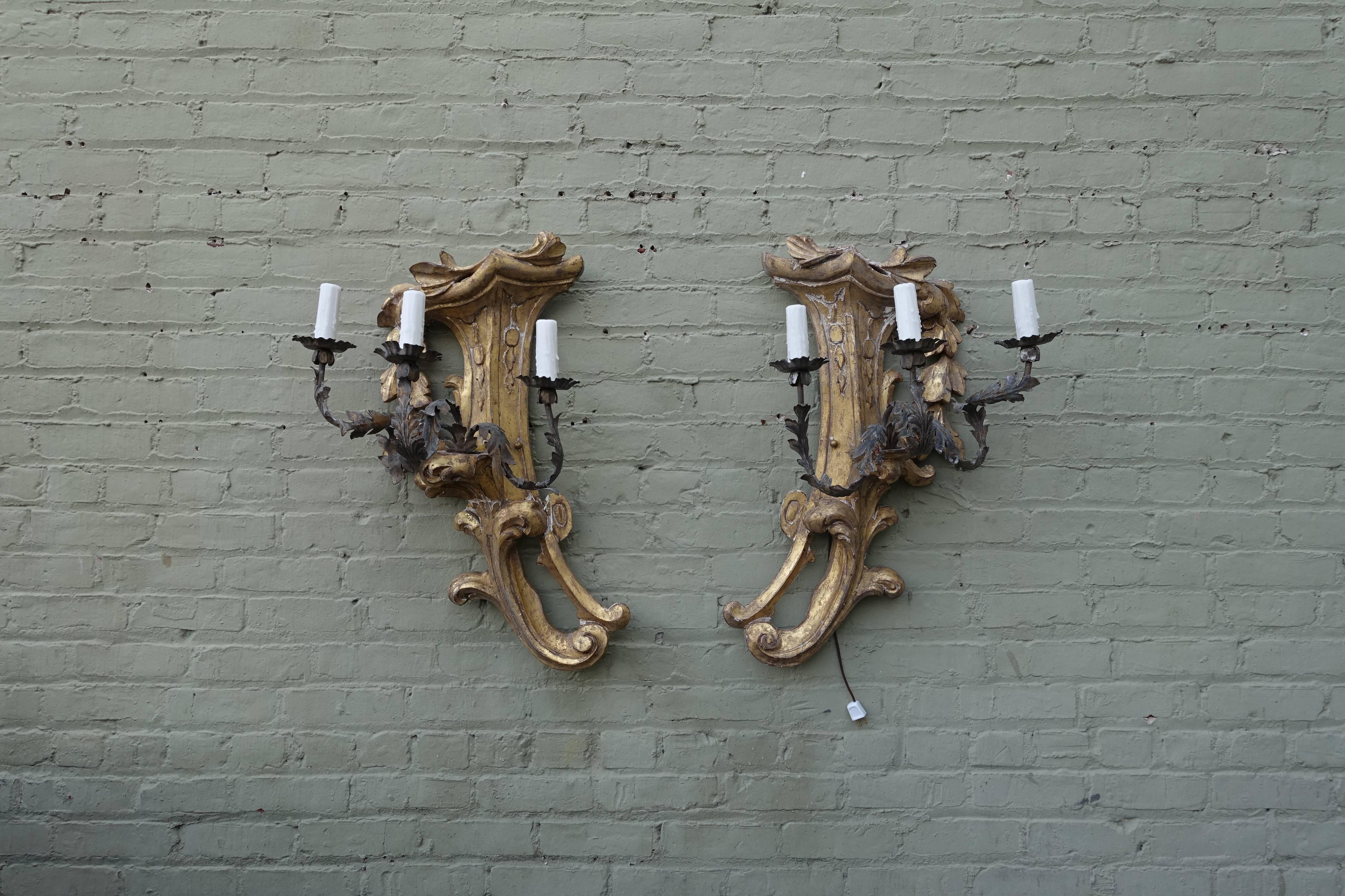 Pair of Italian three-light giltwood & wrought iron sconces. The sconces are newly wired with drip-wax candle covers. Ready to install.
