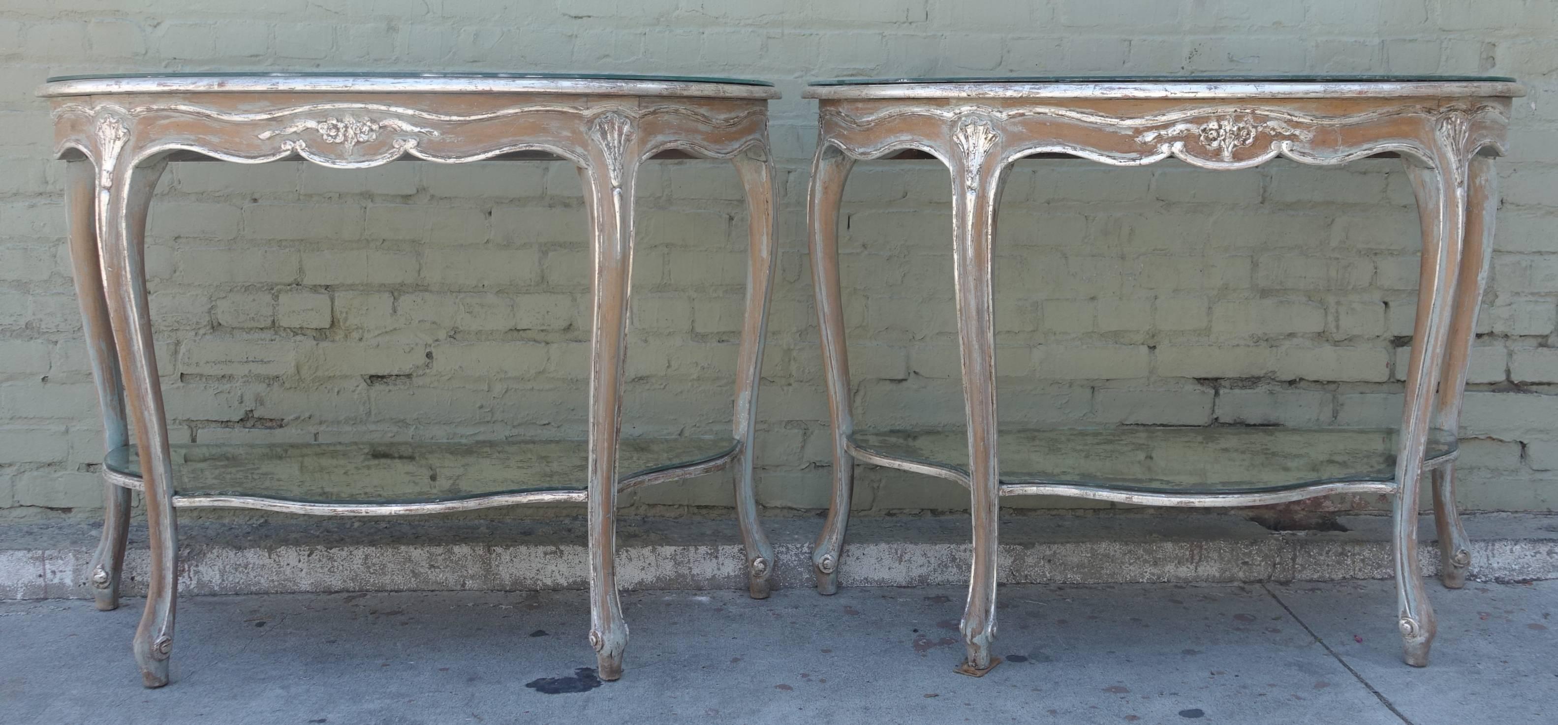 Pair of French Louis XV style painted and silver gilt consoles with bottom mirrored shelf and antiqued mirrored tops.