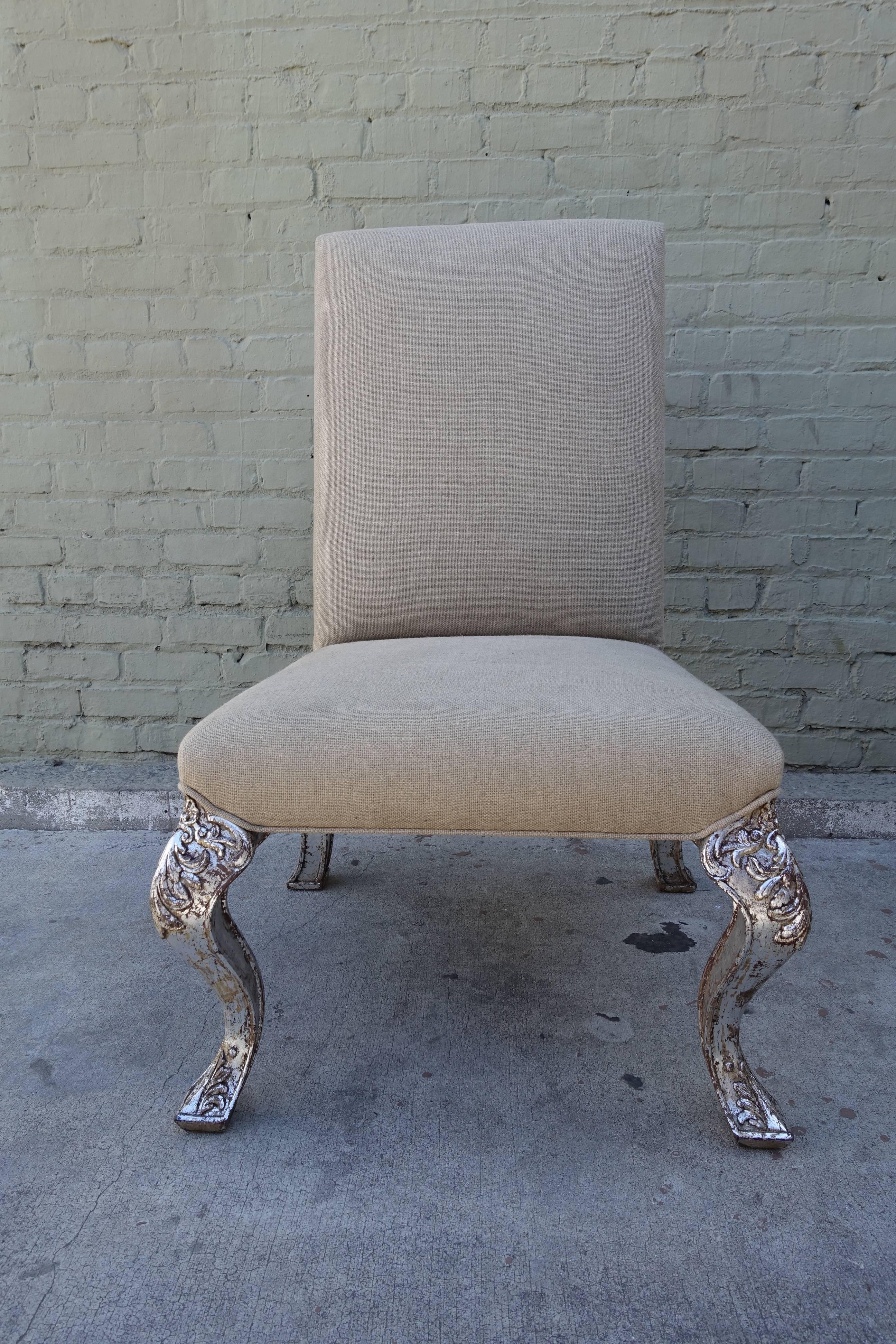 Set of ten French Louis XV style dining chairs newly upholstered in Belgium linen. The carved cabriole legs depicting acanthus leaves are finished in silver leaf.