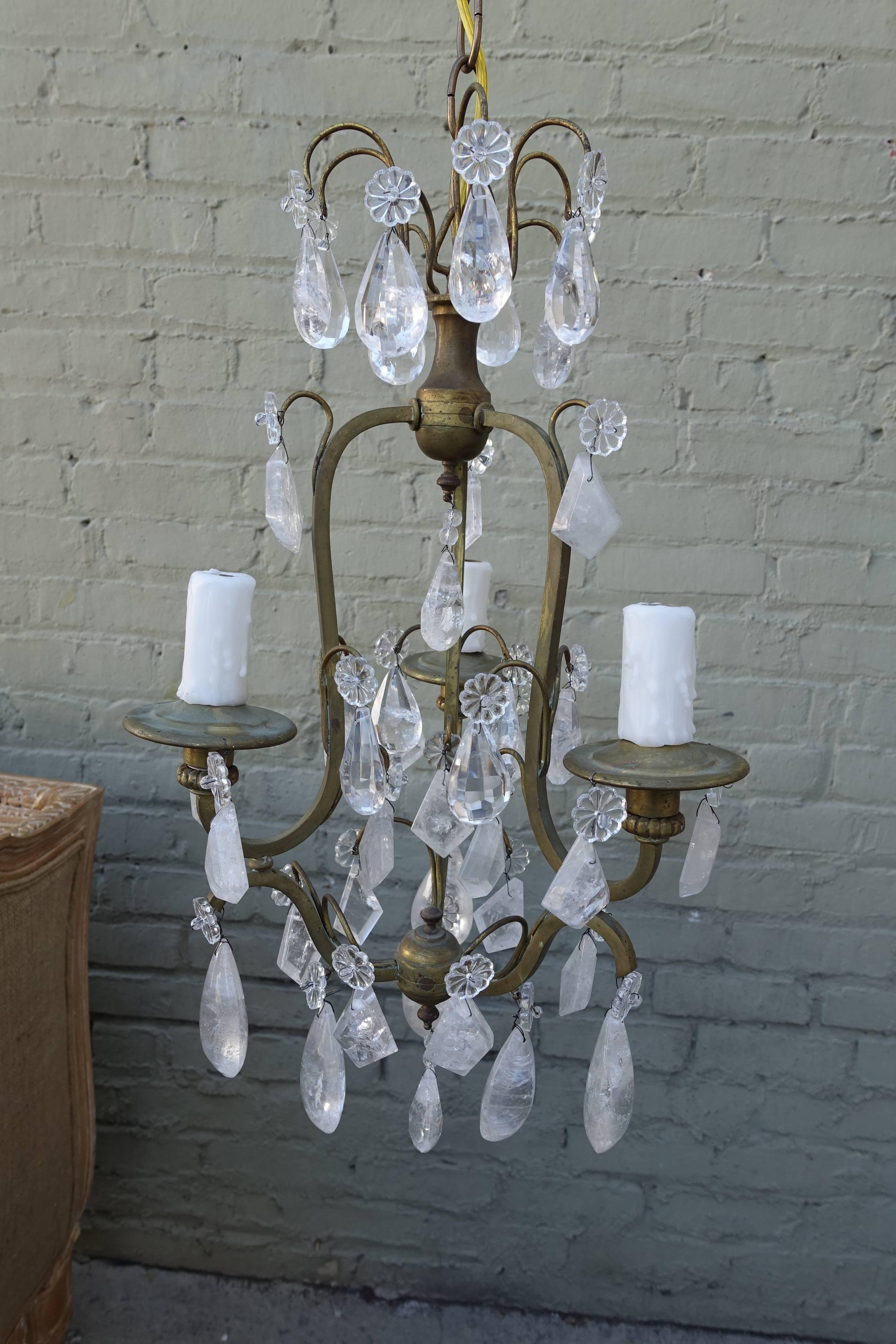 French three-light bronze chandelier adorned with almond and kite shaped rock crystals. Newly wired with drip wax candle covers. Chain and canopy included.