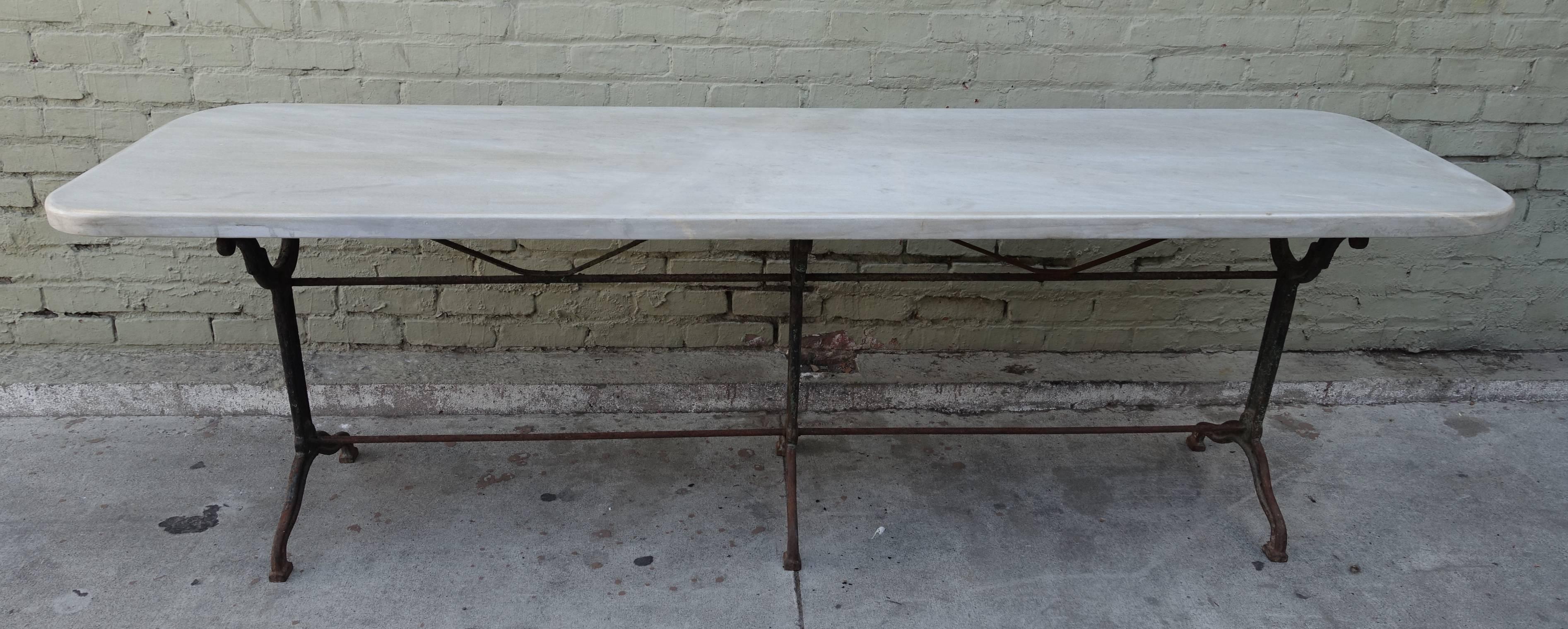 19th century cast iron French table with original thick slab of white French marble.