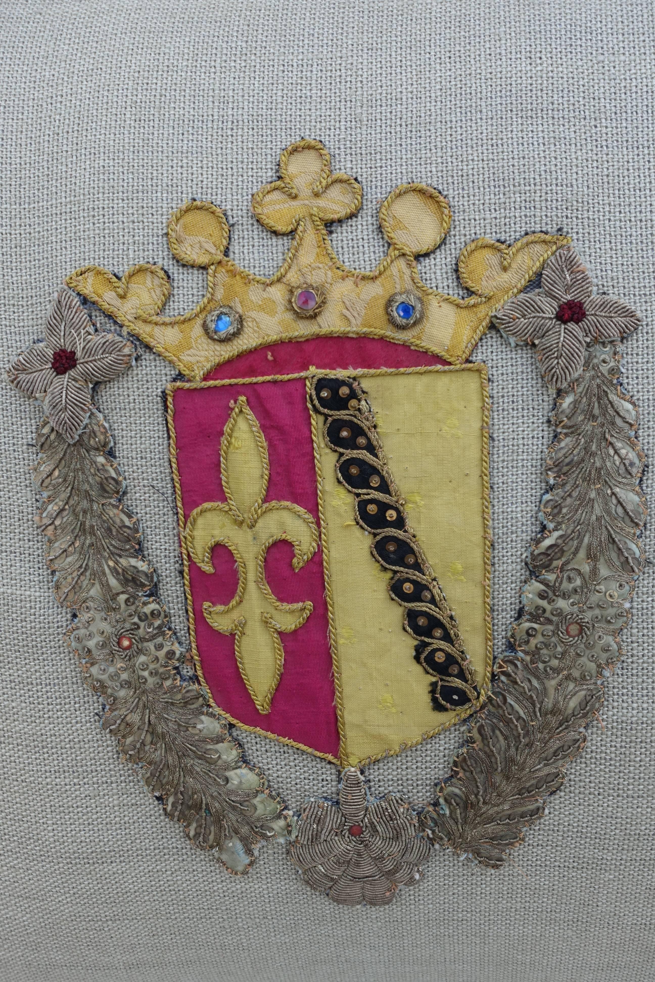 Pair of custom designed pillows made with 19th century metallic and silk family crests appliquéd on Belgium linen with beautiful tassel fringe at sides. Sewn shut.