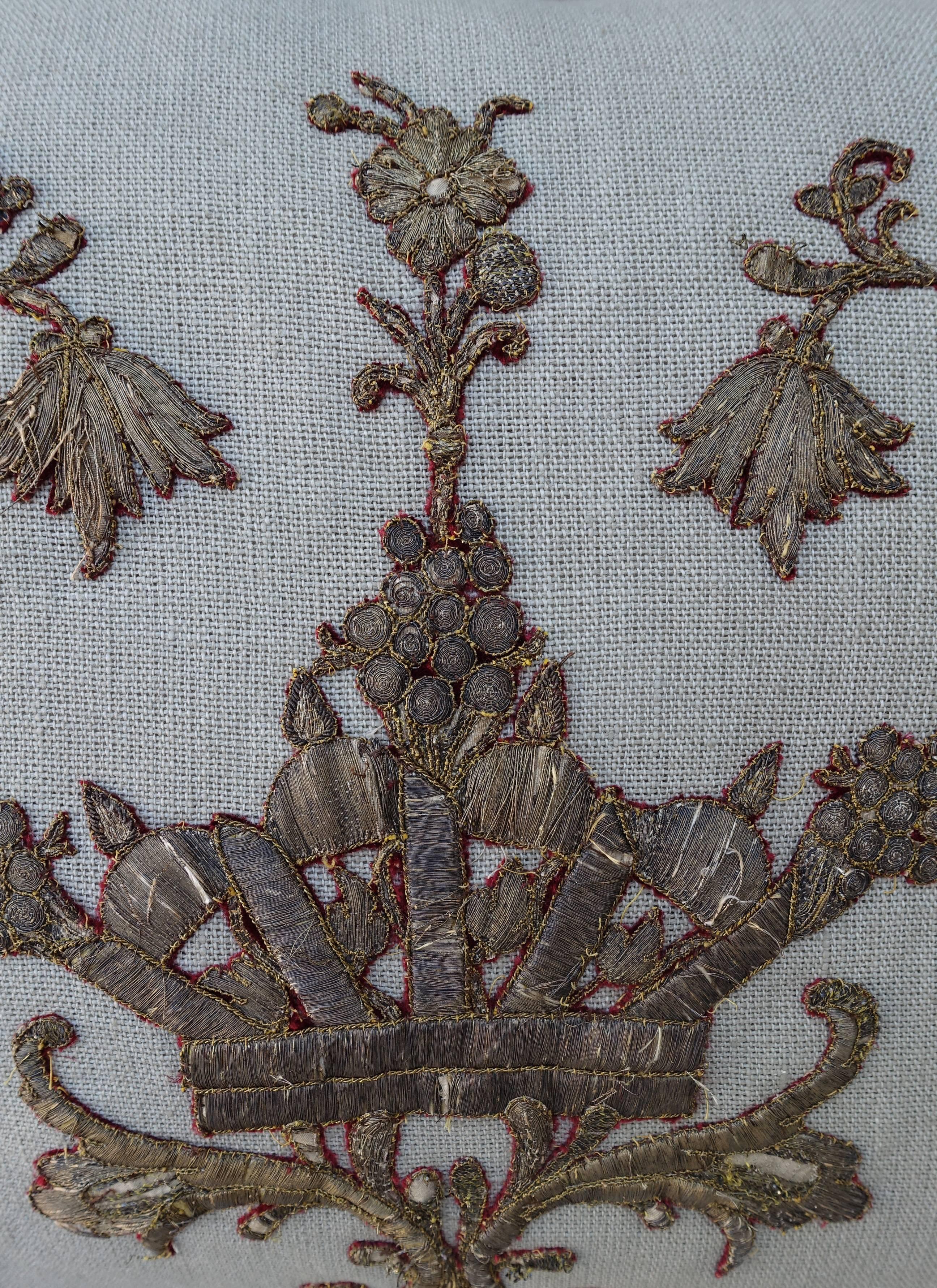 18th century Italian metallic applique of a crown surrounded by flowers on a home spun linen pillow with antique Metallic Fringe at sides. Down insert, sewn shut.